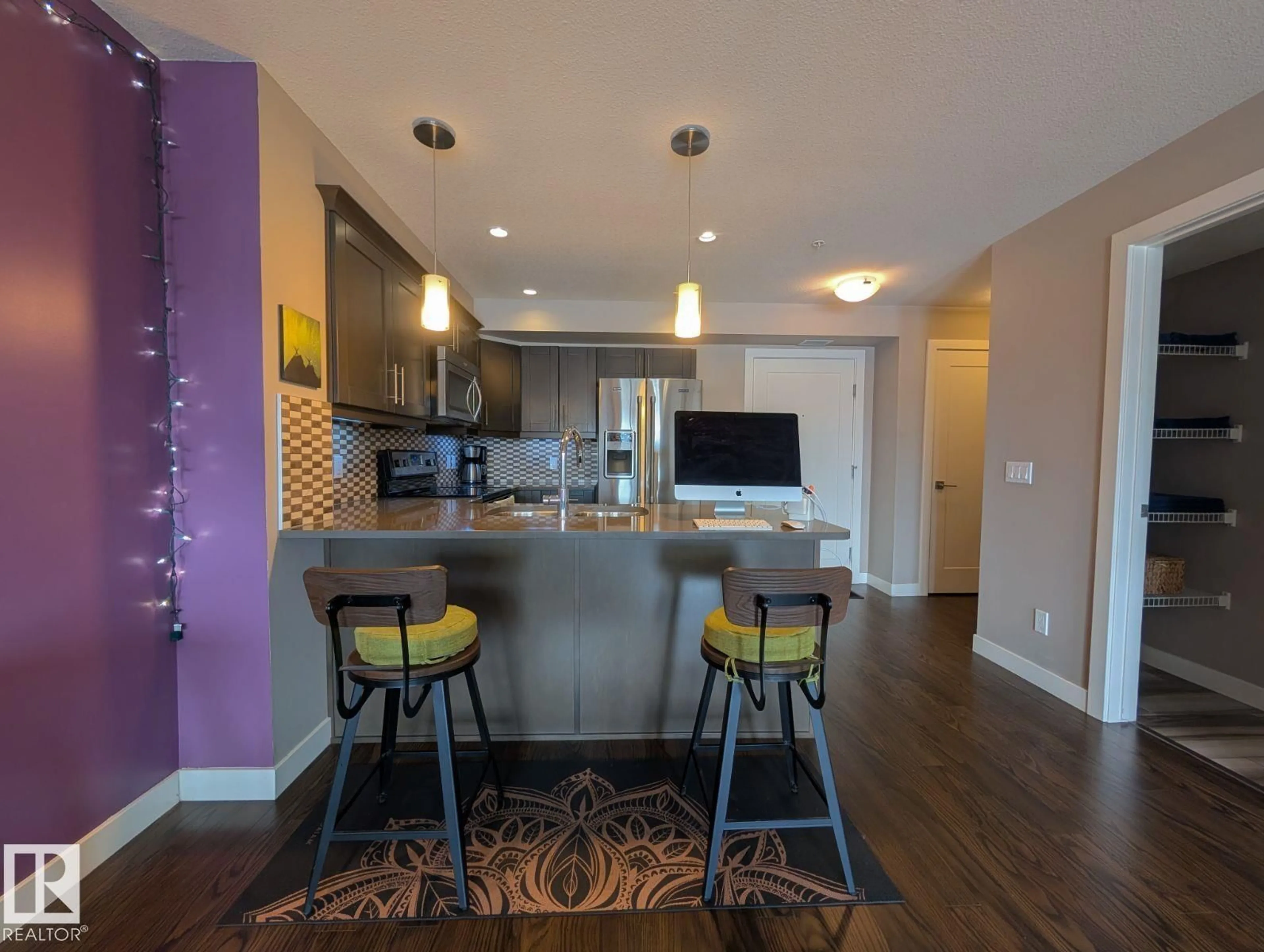 Open concept kitchen, wood/laminate floor for #208 - 1031 173 ST, Edmonton Alberta T6W3E4