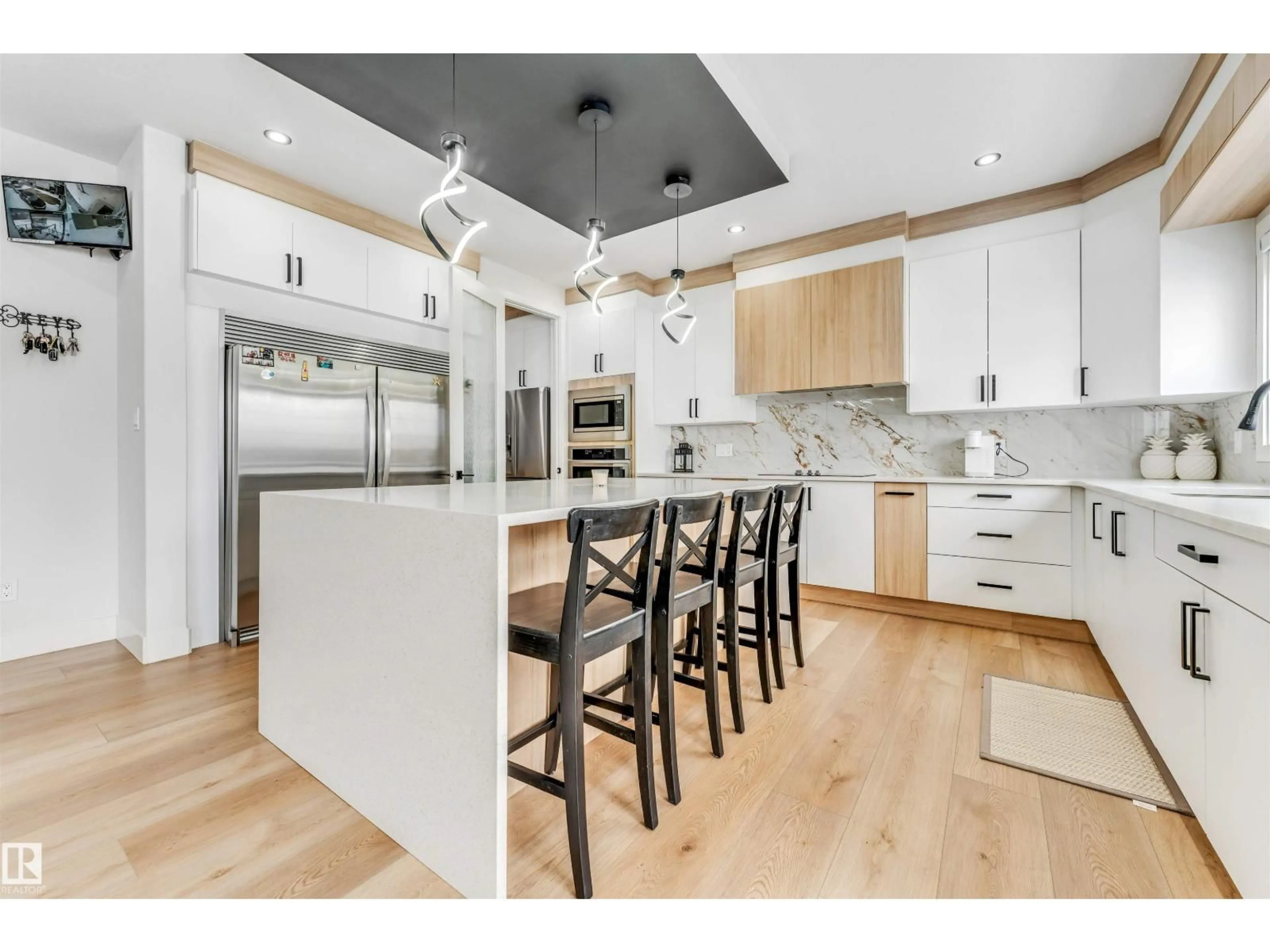 Open concept kitchen, wood/laminate floor for 304 33 AV, Edmonton Alberta T6T2V8