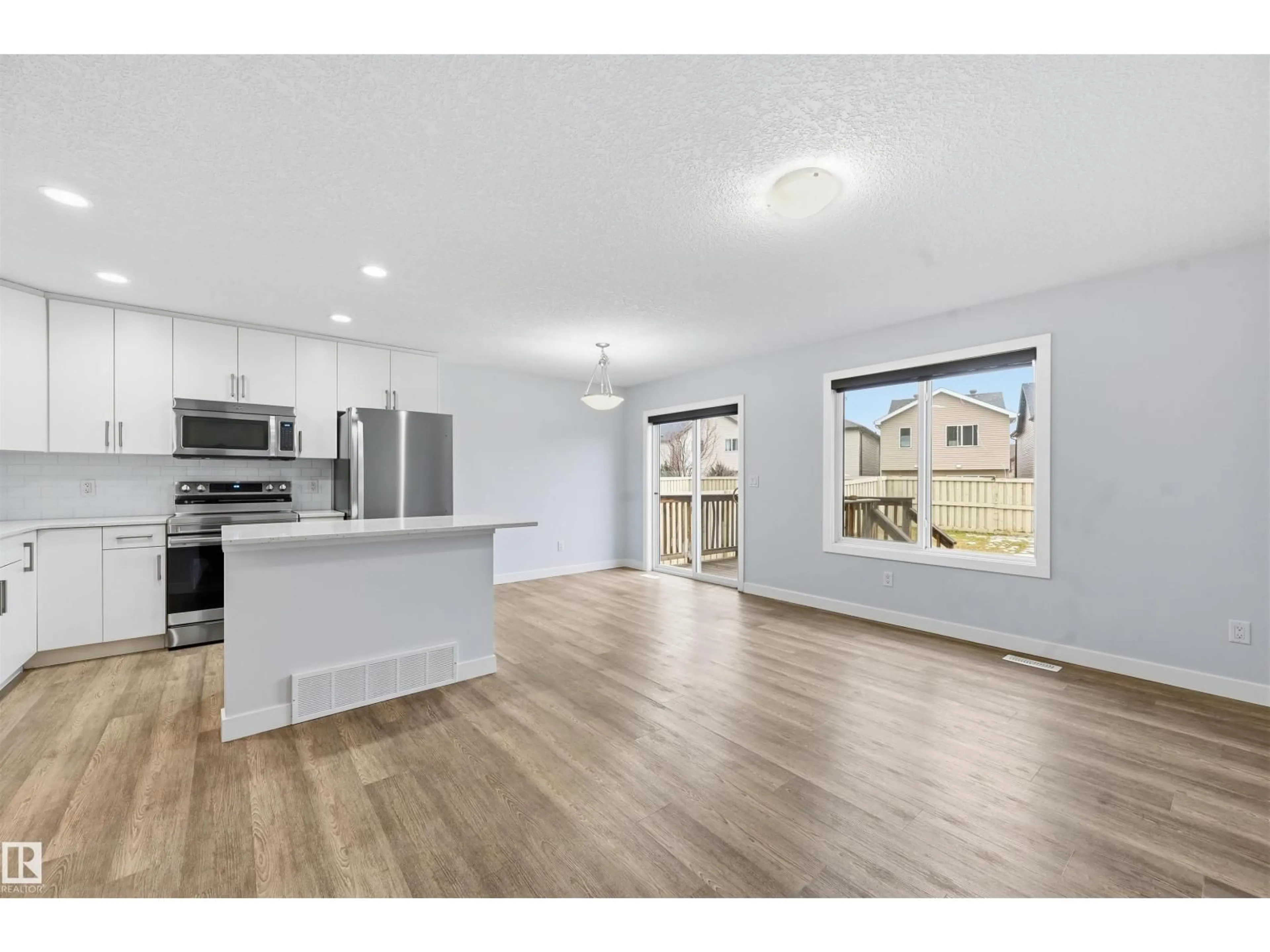 Open concept kitchen, wood/laminate floor for 3609 ATKINSON LO, Edmonton Alberta T6W0X3