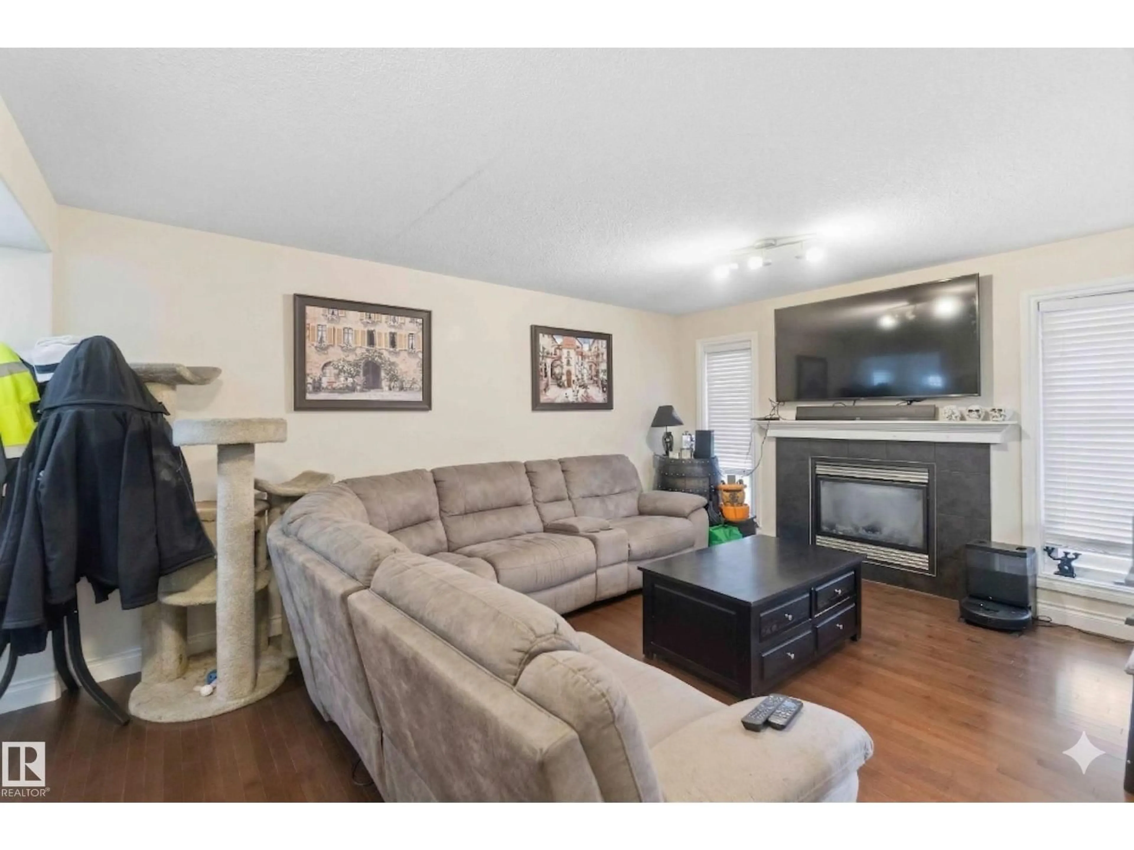 Living room with furniture, wood/laminate floor for SW - 2037 69A ST, Edmonton Alberta T6X0S5