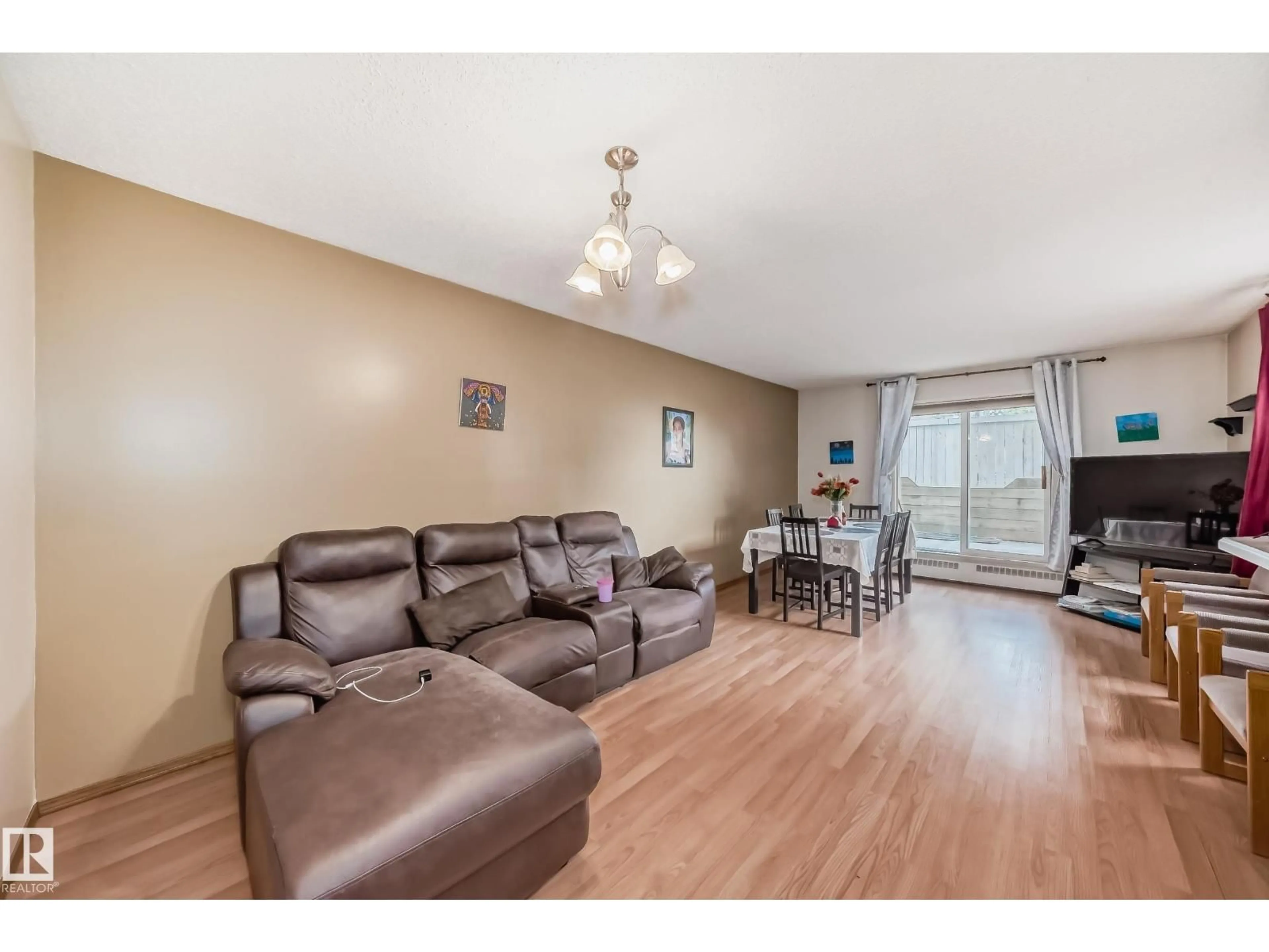 Living room with furniture, wood/laminate floor for #101 - 17467 98A AV, Edmonton Alberta T5T6E9