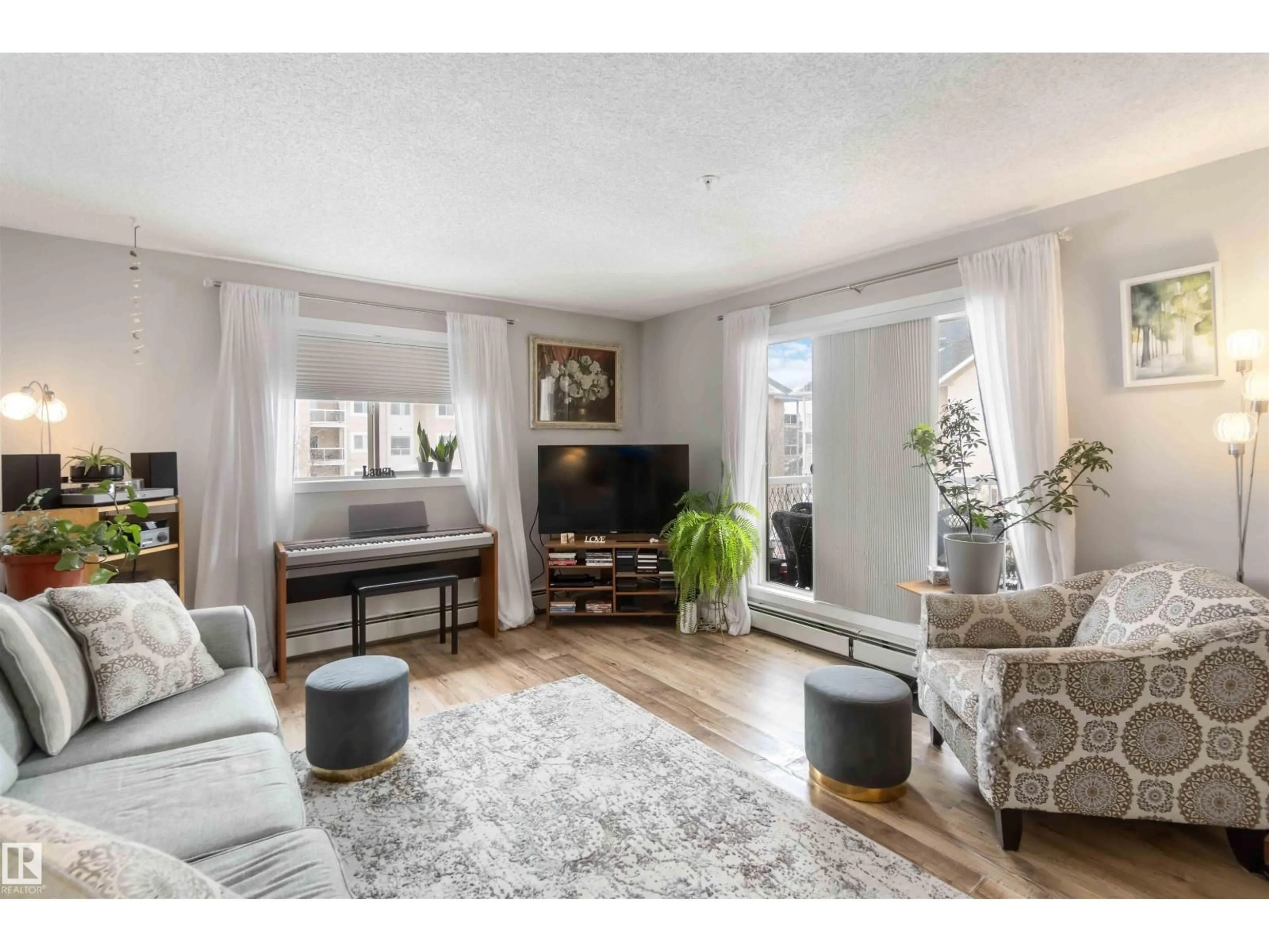 Living room with furniture, wood/laminate floor for 329 17447 98A AV, Edmonton Alberta T5T6M4