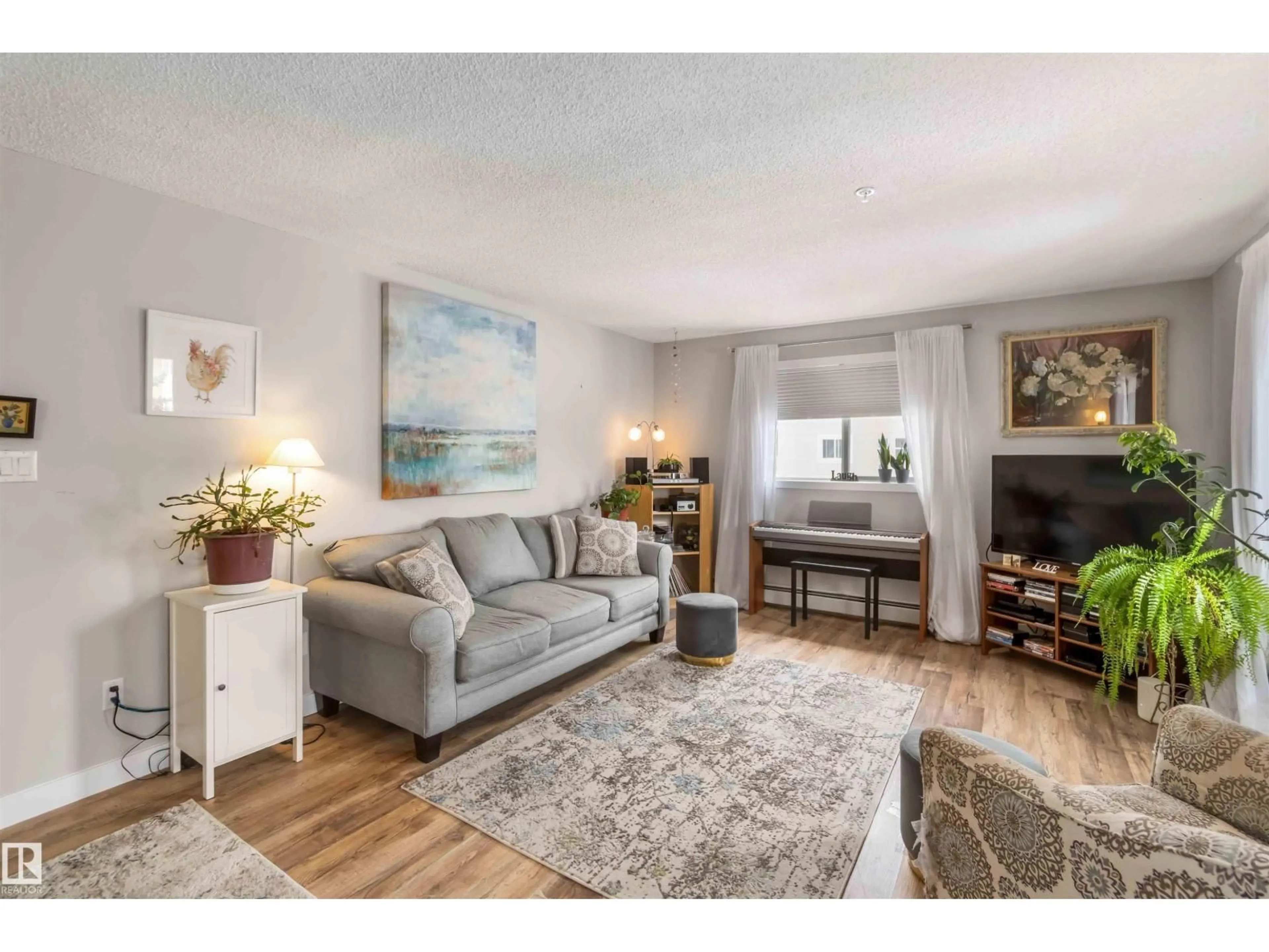 Living room with furniture, wood/laminate floor for 329 17447 98A AV, Edmonton Alberta T5T6M4