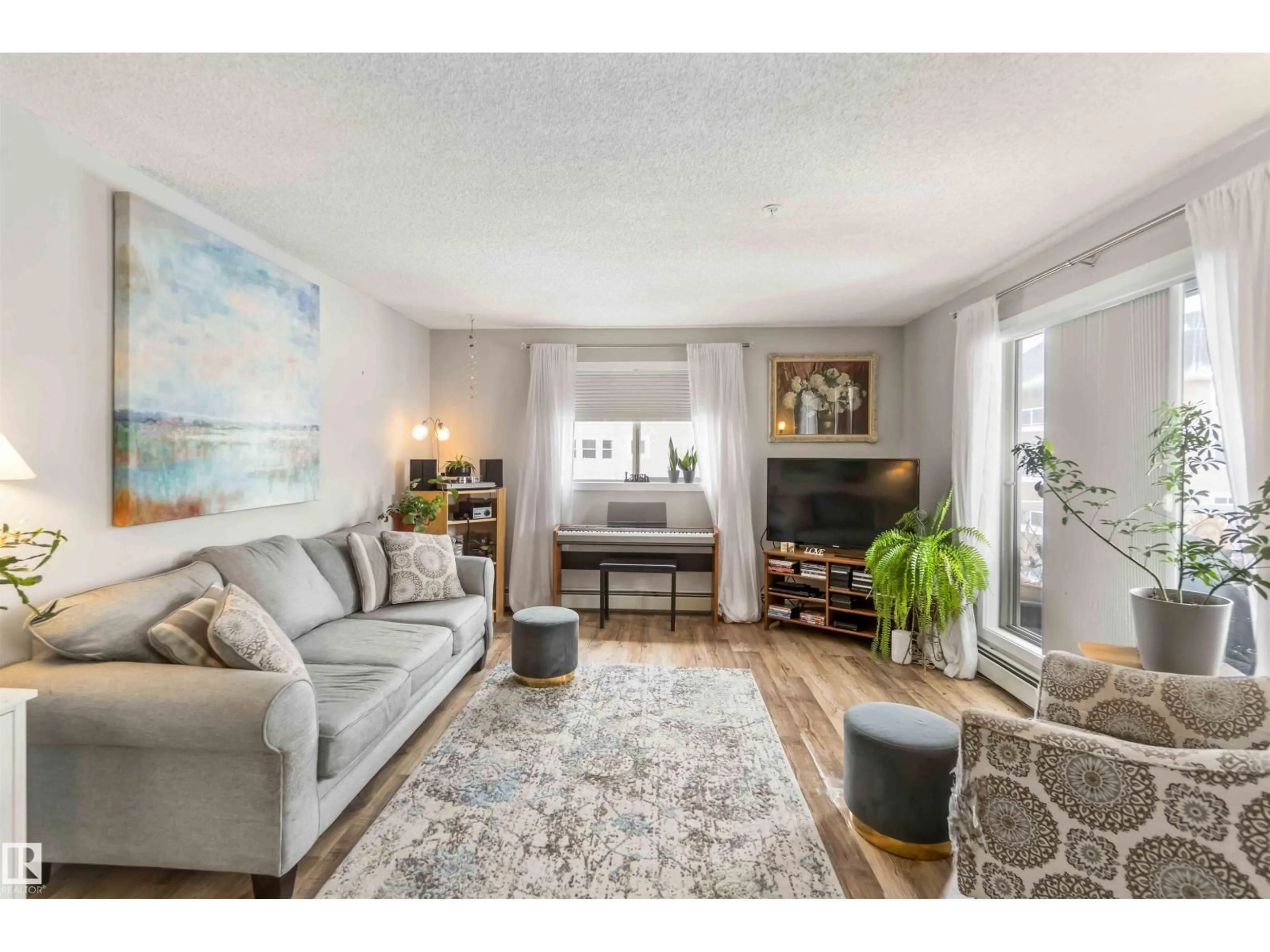Living room with furniture, wood/laminate floor for 329 17447 98A AV, Edmonton Alberta T5T6M4
