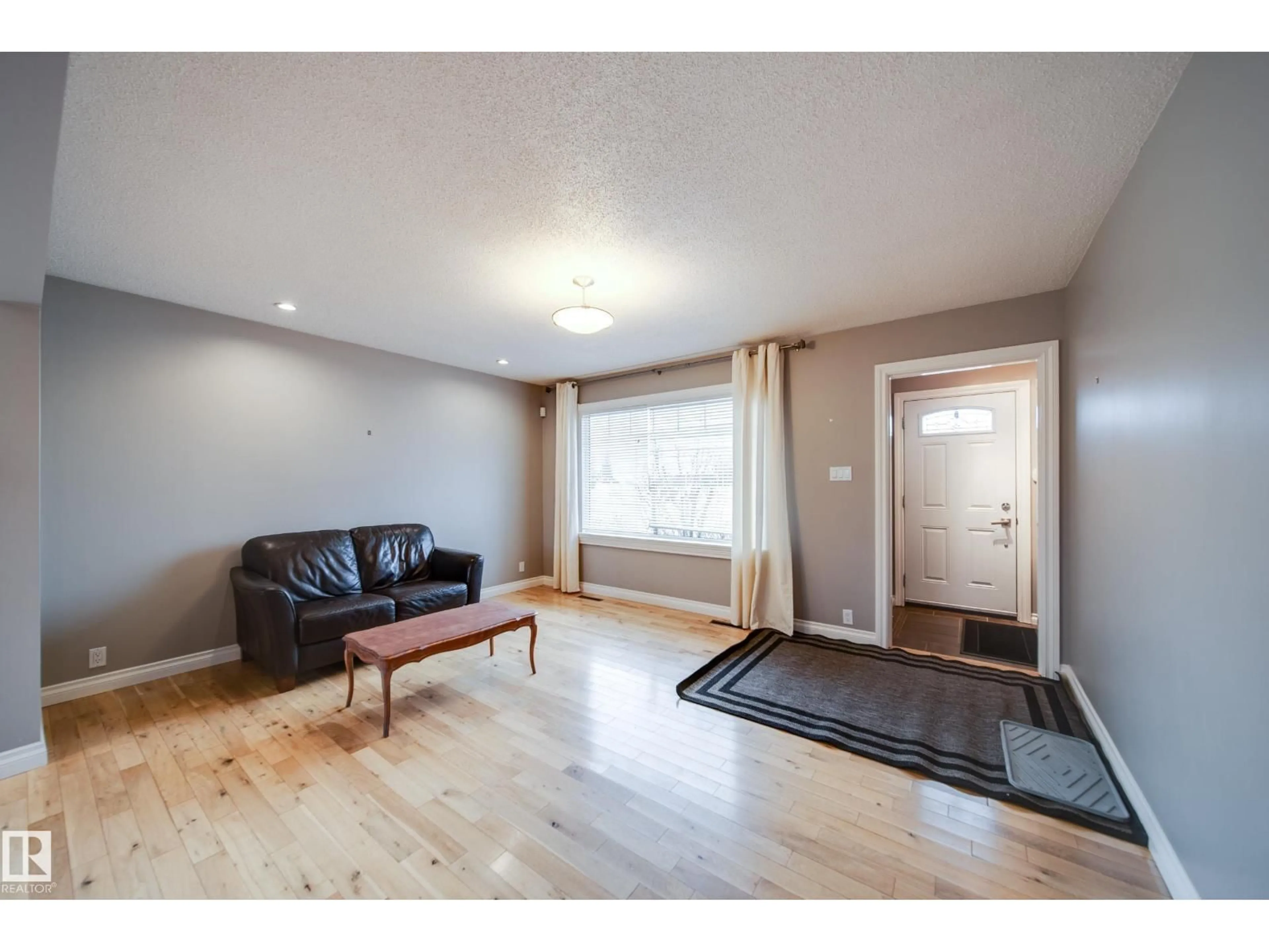 Living room with furniture, wood/laminate floor for NW - 6052 105B ST, Edmonton Alberta T6H2S5