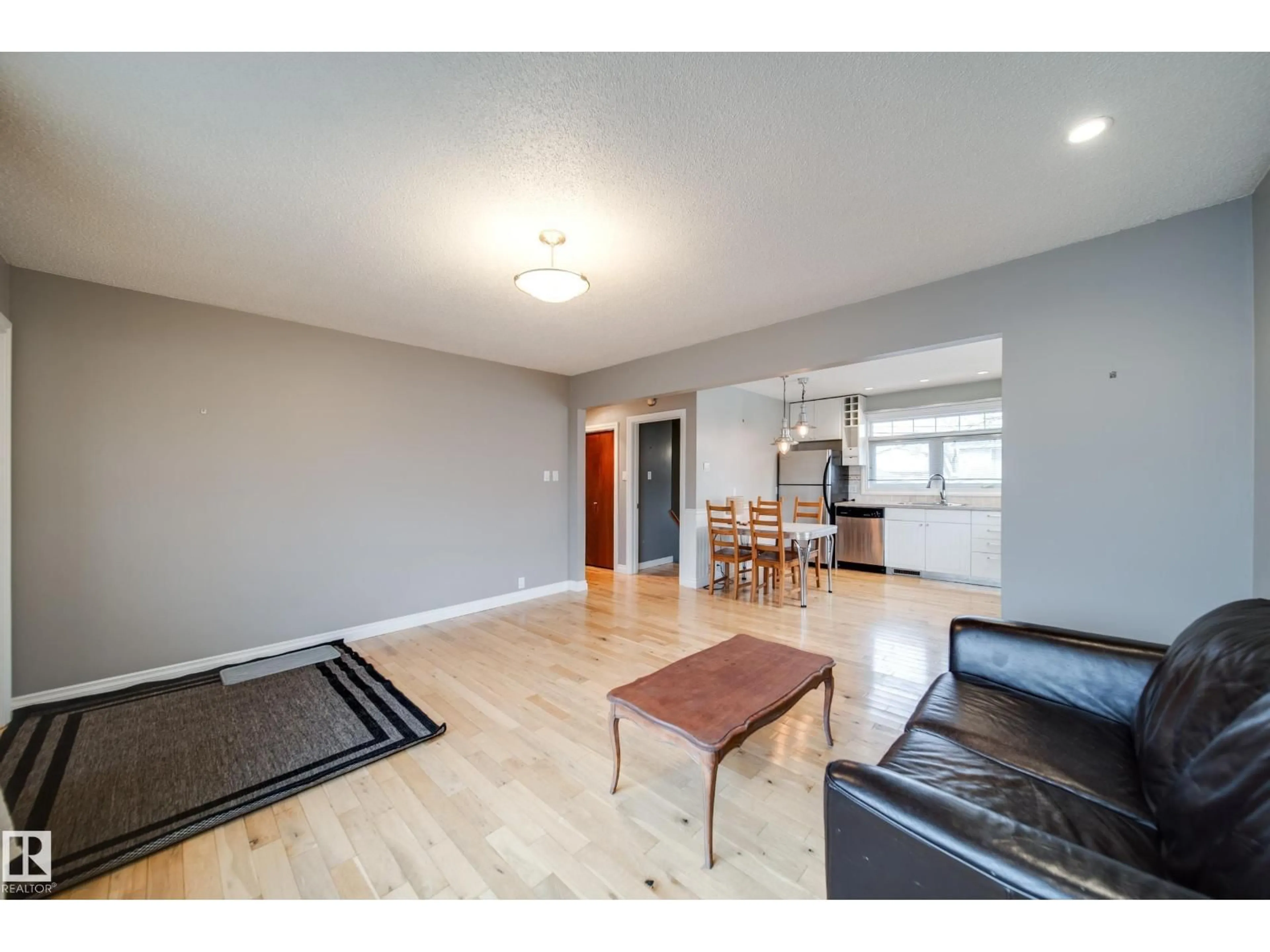 Living room with furniture, wood/laminate floor for NW - 6052 105B ST, Edmonton Alberta T6H2S5