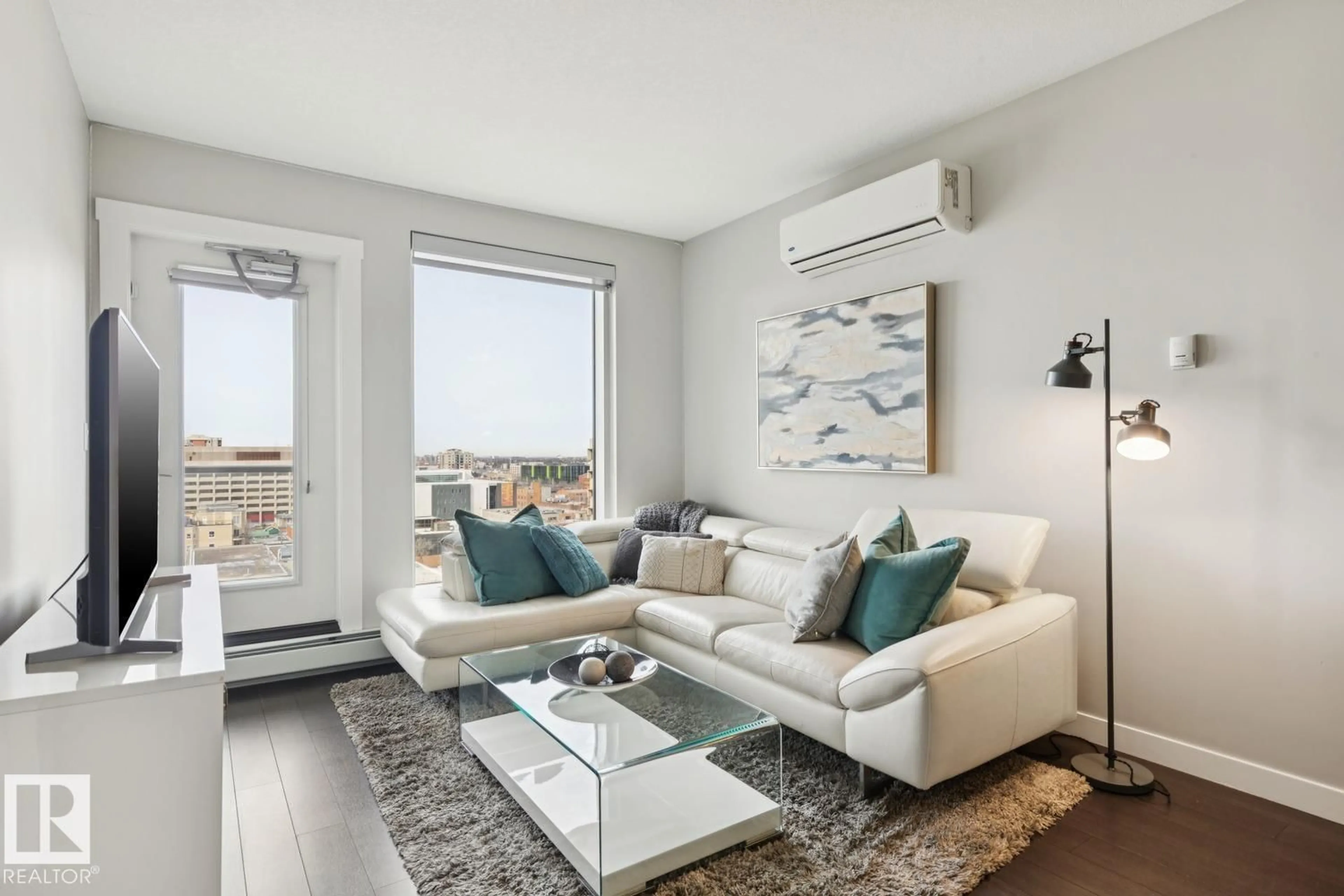 Living room with furniture, wood/laminate floor for 905 - 10410 102 AV, Edmonton Alberta T5J0E9