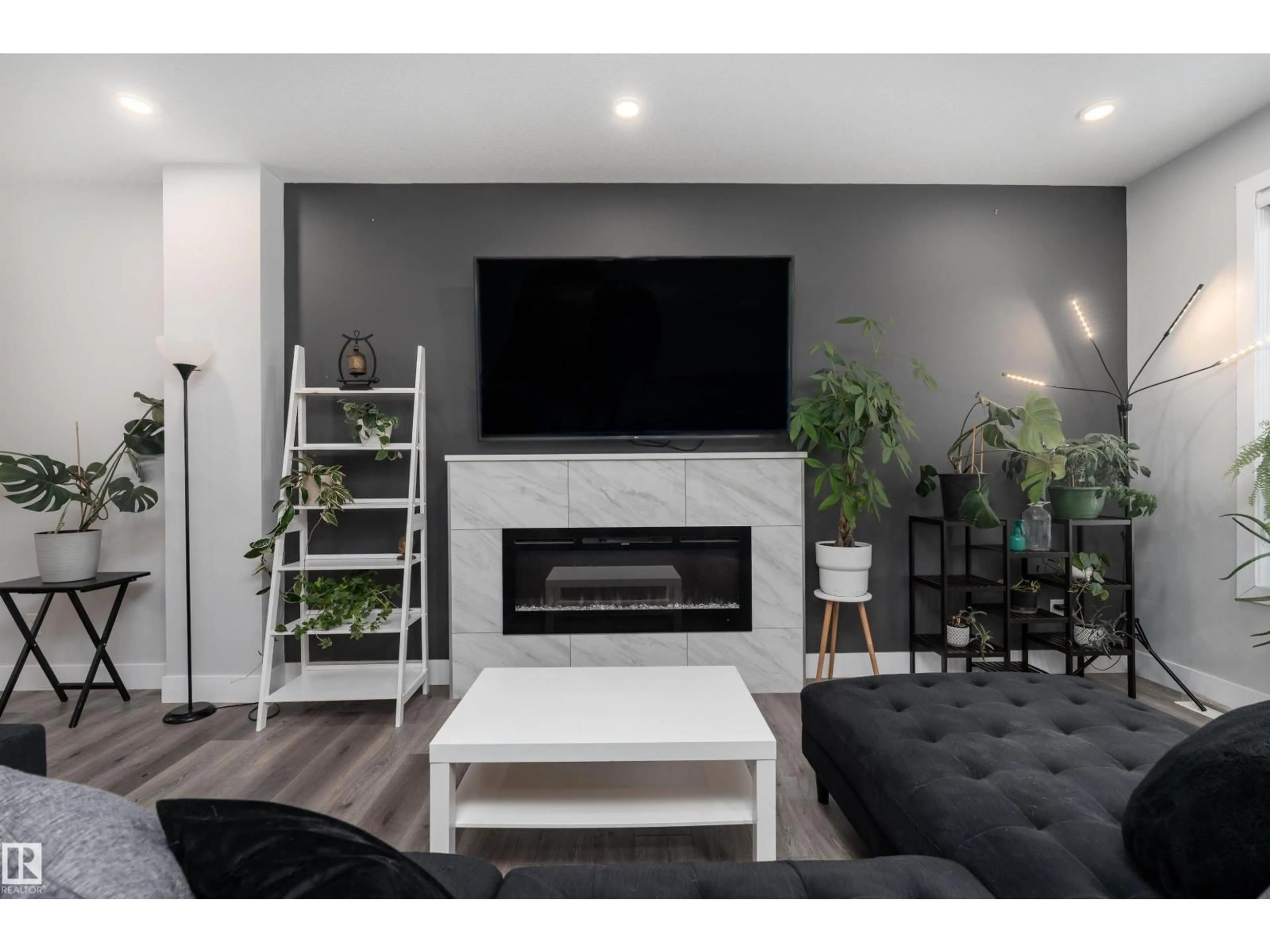 Living room with furniture, wood/laminate floor for 9338 PEAR LI SW, Edmonton Alberta T6X2V9