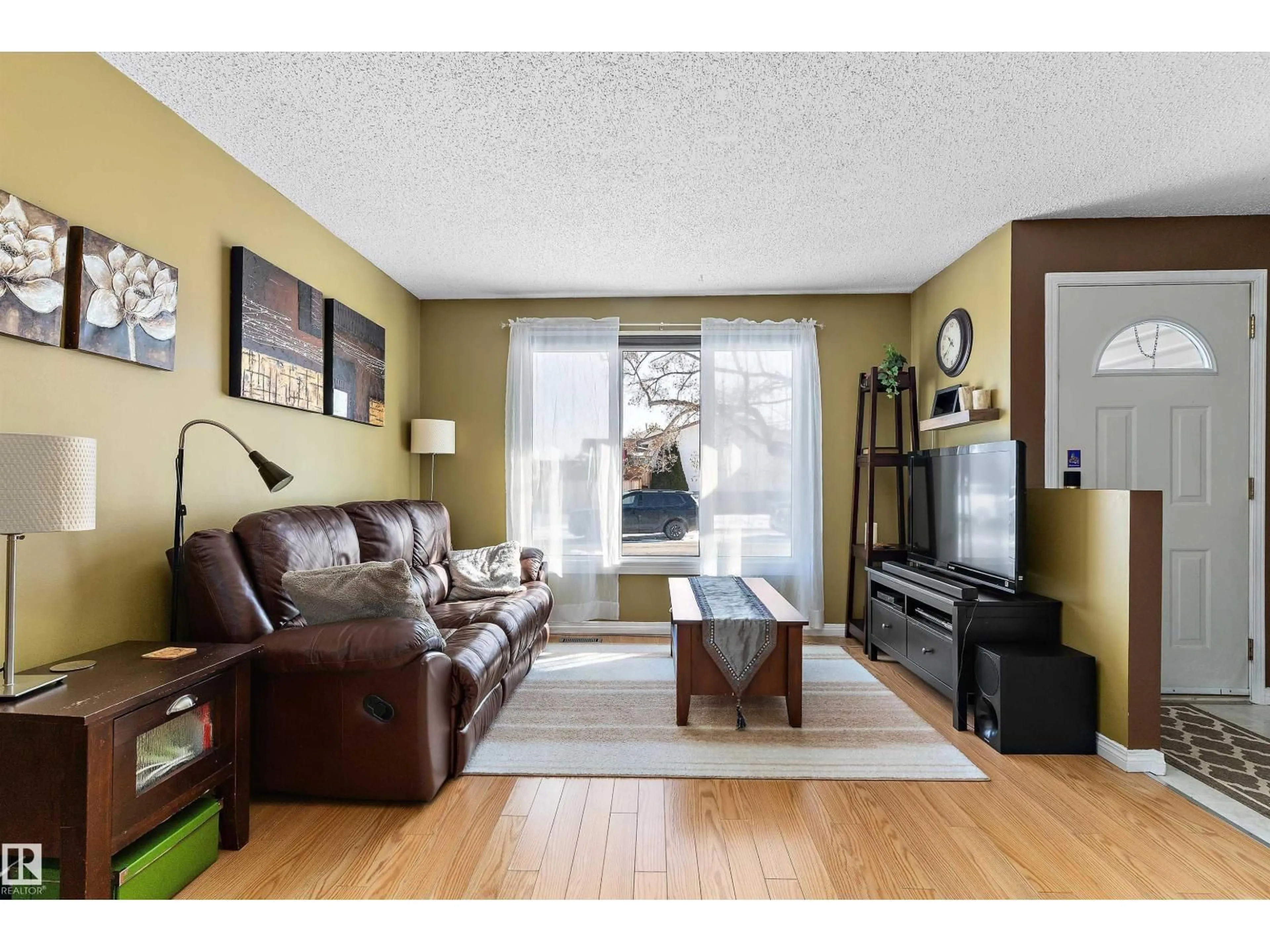 Living room with furniture, wood/laminate floor for 17132 103 ST, Edmonton Alberta T5X4Z4