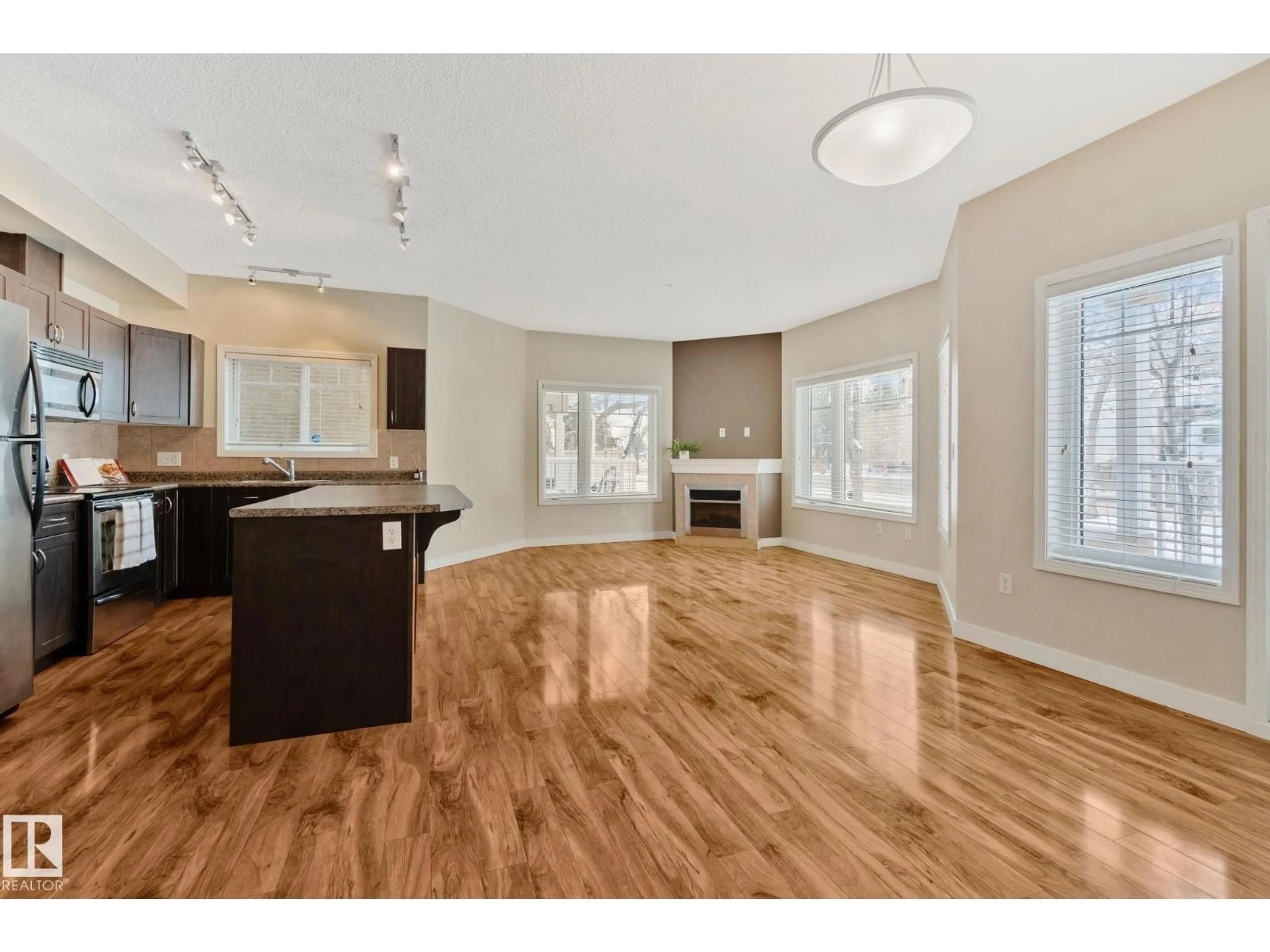 Open concept kitchen, wood/laminate floor for #120 - 8931 156 ST, Edmonton Alberta T5R1Y6
