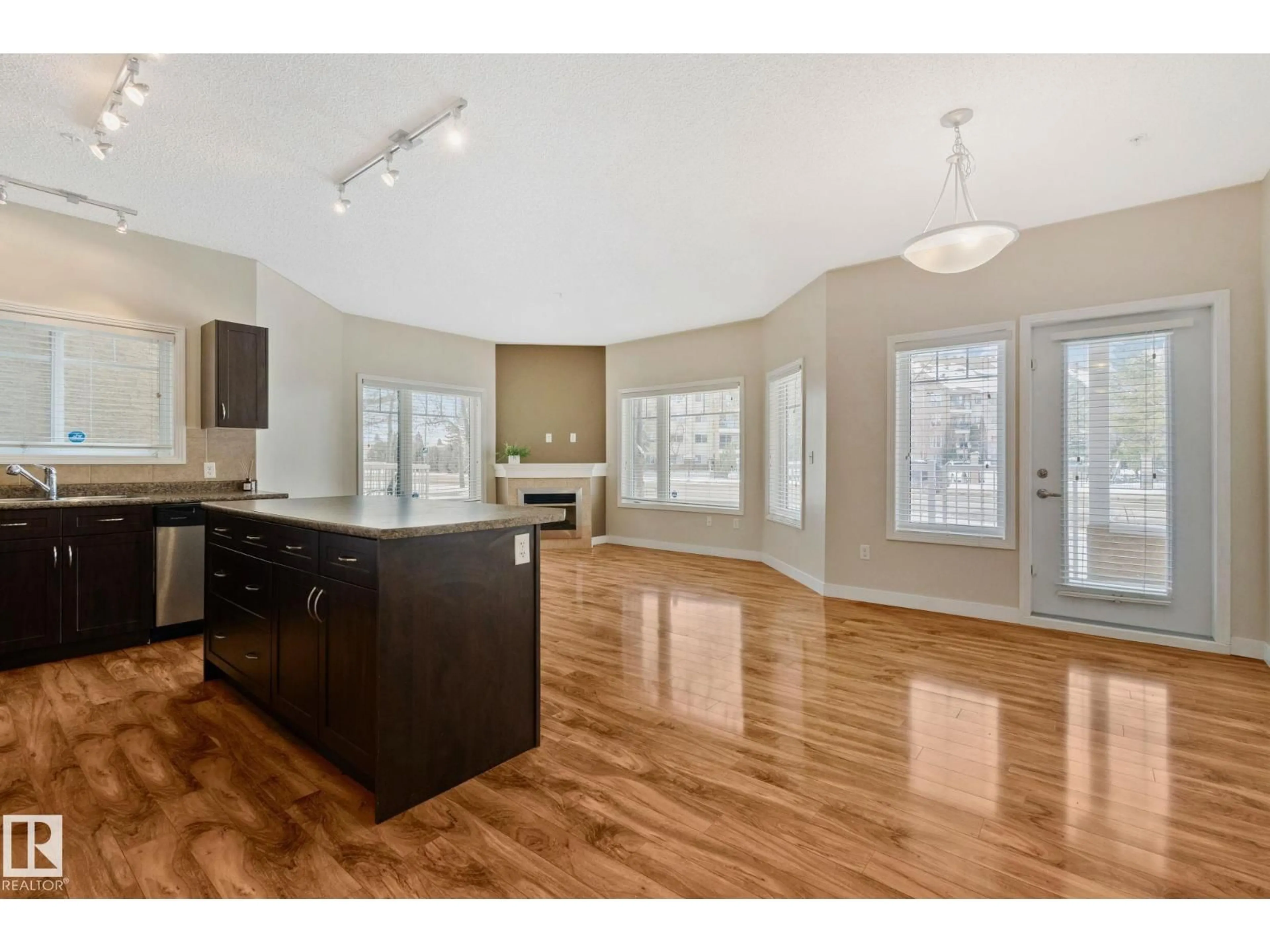 Open concept kitchen, wood/laminate floor for #120 - 8931 156 ST, Edmonton Alberta T5R1Y6