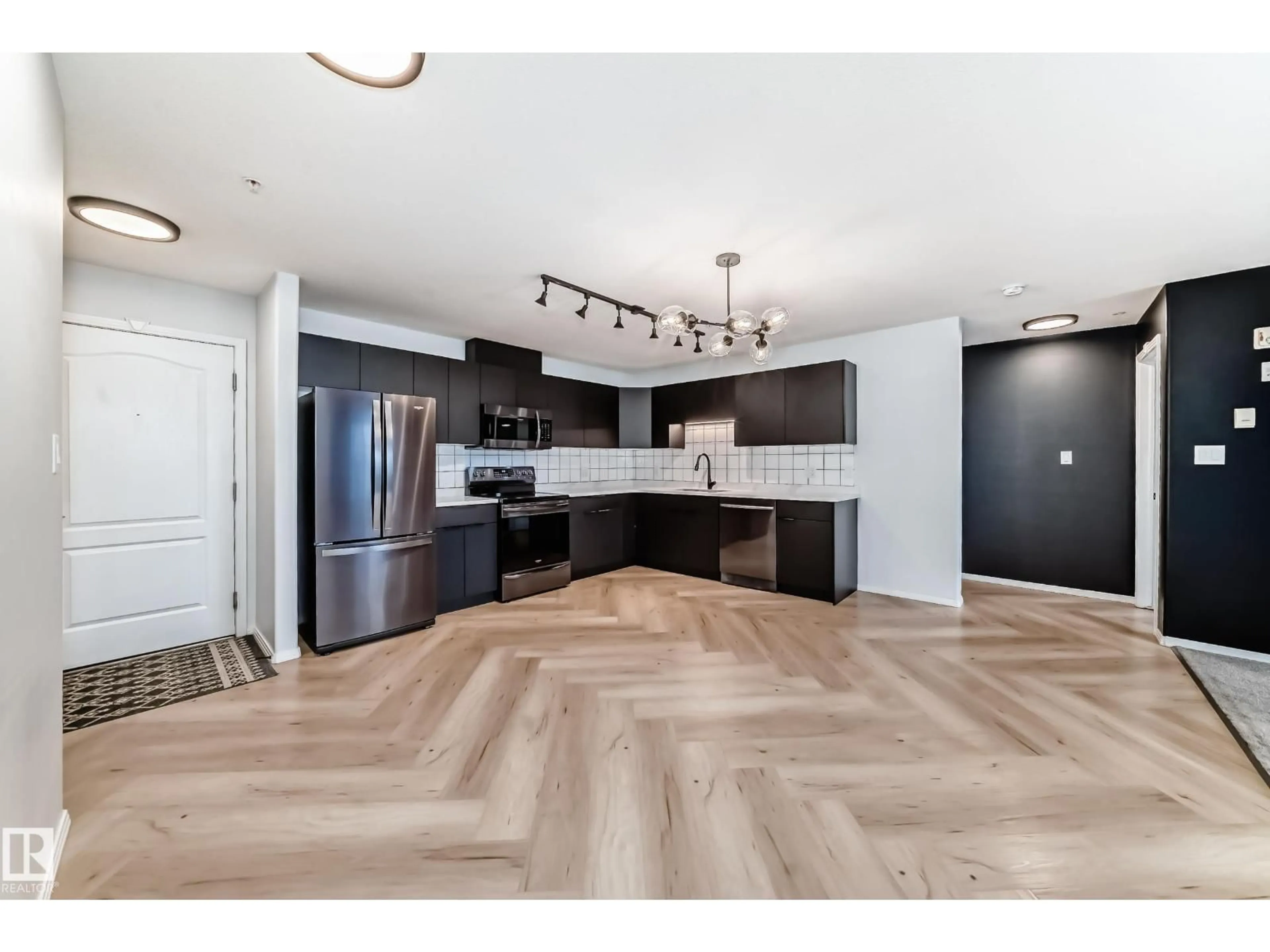 Open concept kitchen, wood/laminate floor for #320 - 592 HOOKE RD, Edmonton Alberta T5A5H2