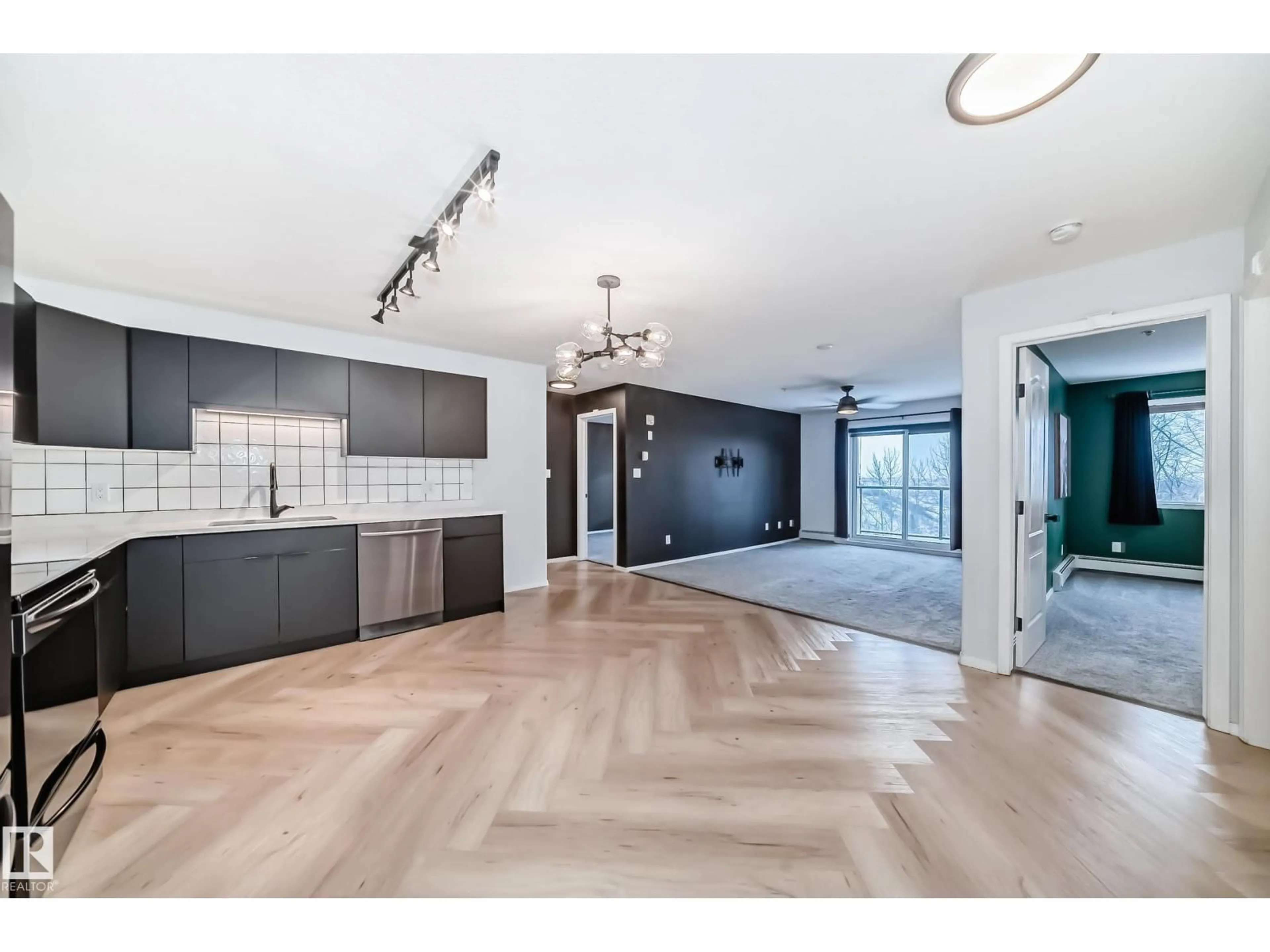Open concept kitchen, wood/laminate floor for #320 - 592 HOOKE RD, Edmonton Alberta T5A5H2