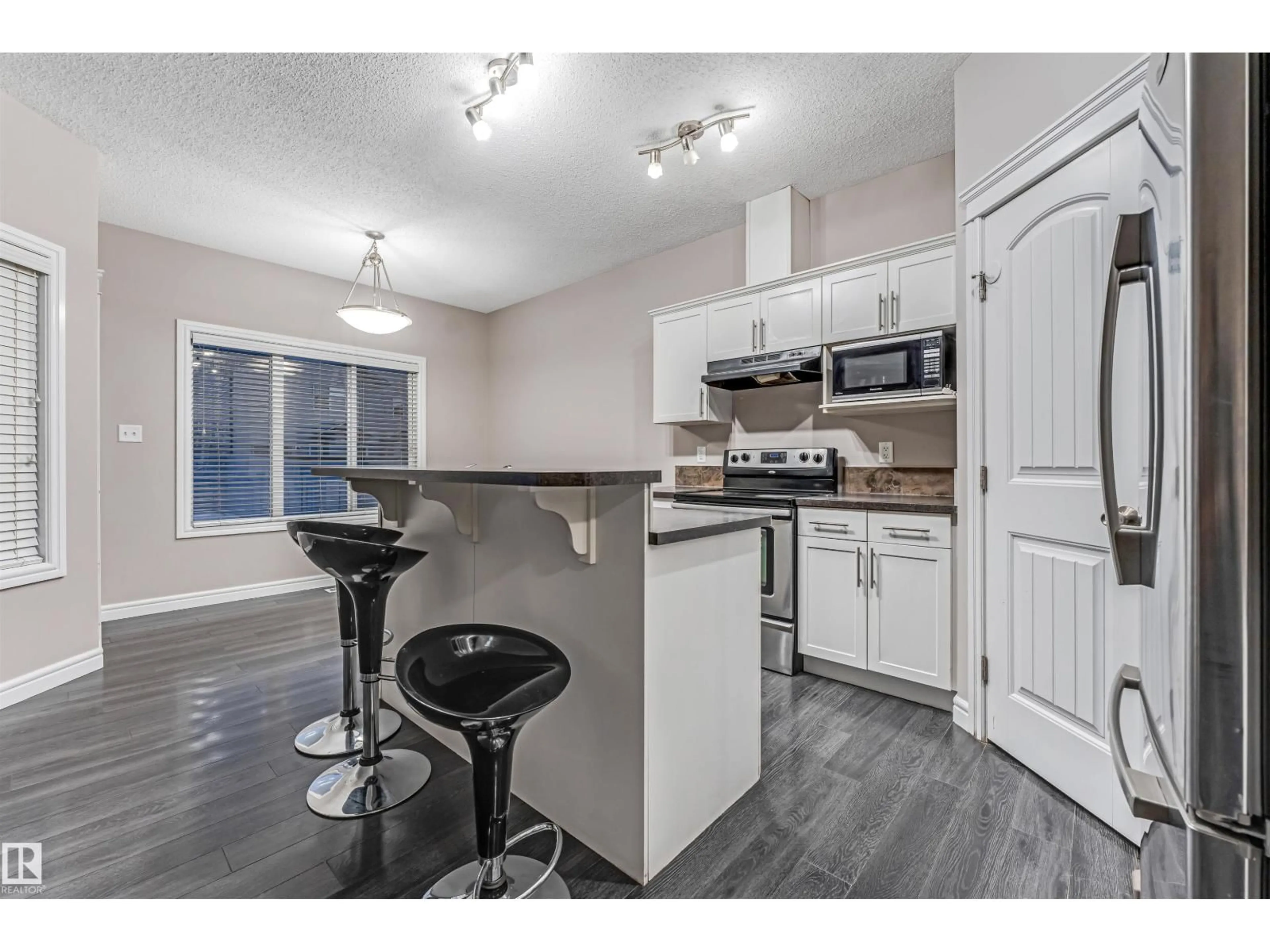 Open concept kitchen, wood/laminate floor for 2929 16A AV, Edmonton Alberta T6T0P8