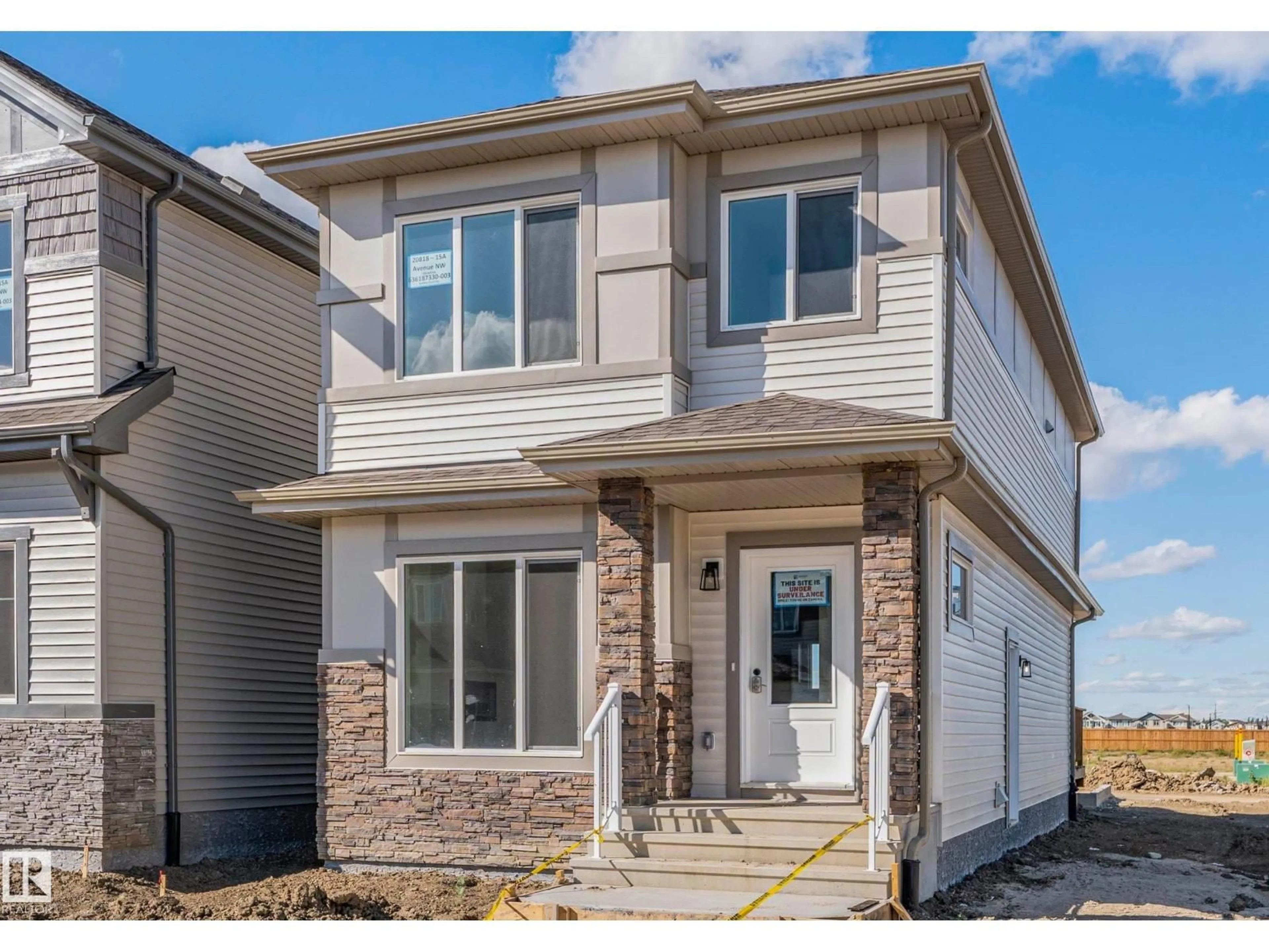 Home with vinyl exterior material, street for 20818 15A AV, Edmonton Alberta T6M1K7