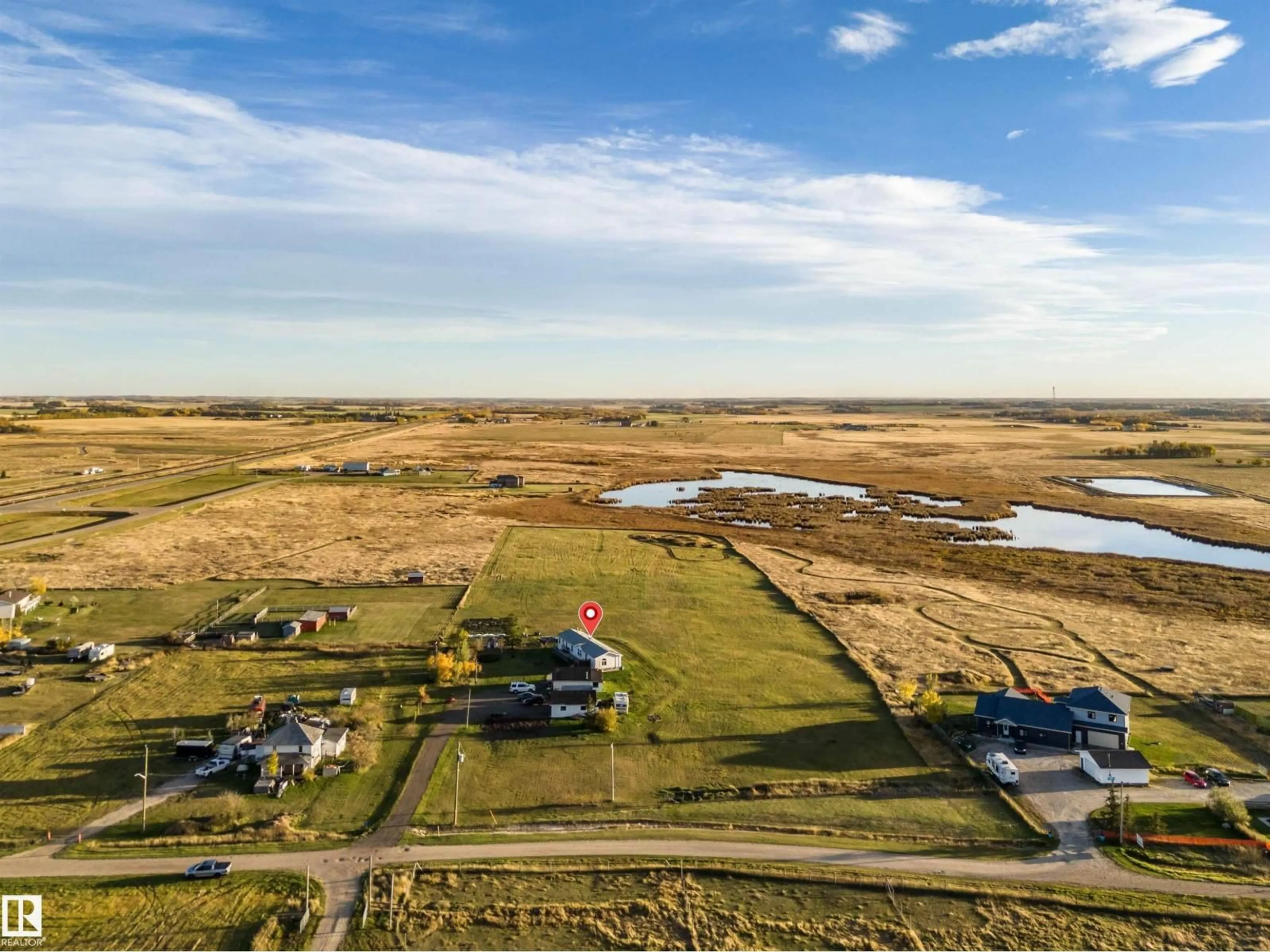 A pic from outside/outdoor area/front of a property/back of a property/a pic from drone, water/lake/river/ocean view for 1050 HWY 2, Rural Leduc County Alberta T4X2S4