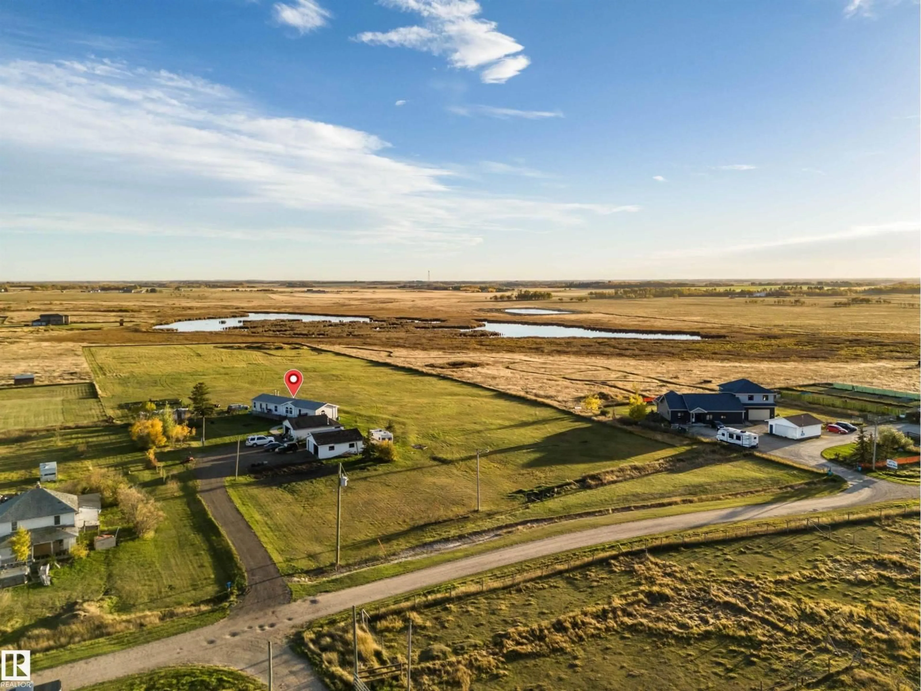 A pic from outside/outdoor area/front of a property/back of a property/a pic from drone, water/lake/river/ocean view for 1050 HWY 2, Rural Leduc County Alberta T4X2S4