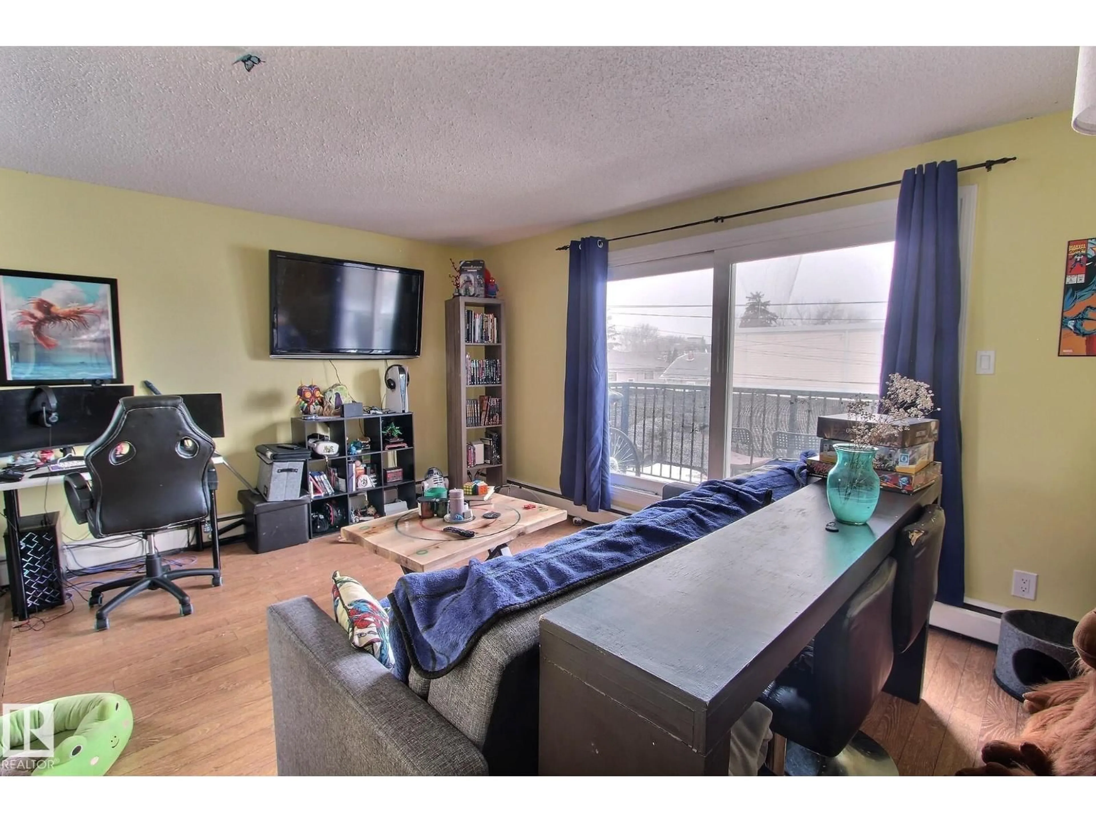 Living room with furniture, wood/laminate floor for 305 - 10740 105 ST NW, Edmonton Alberta T5H2X2