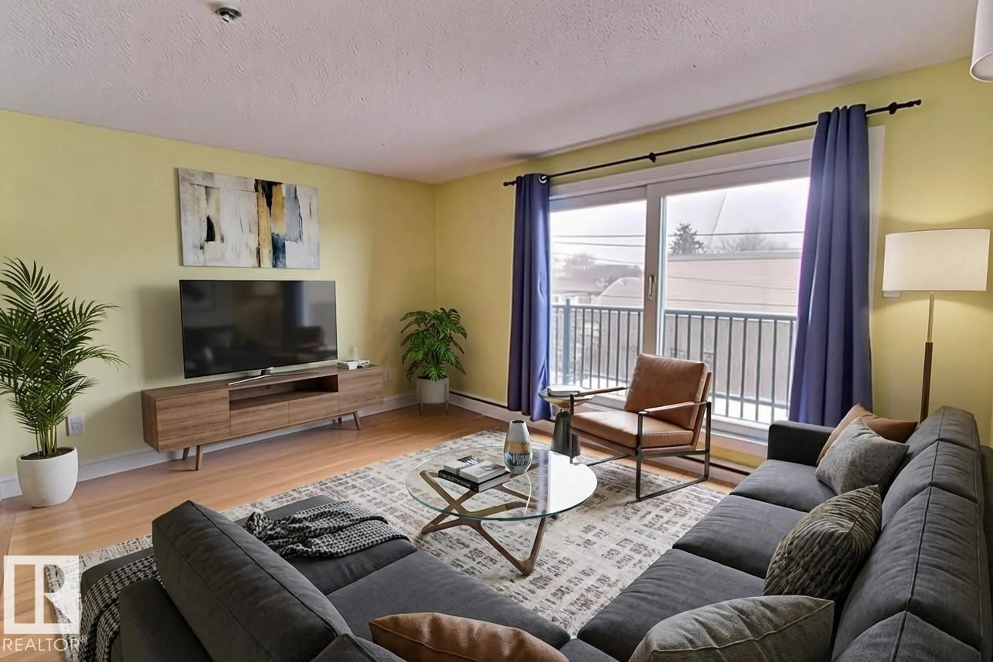 Living room with furniture, wood/laminate floor for 305 - 10740 105 ST NW, Edmonton Alberta T5H2X2