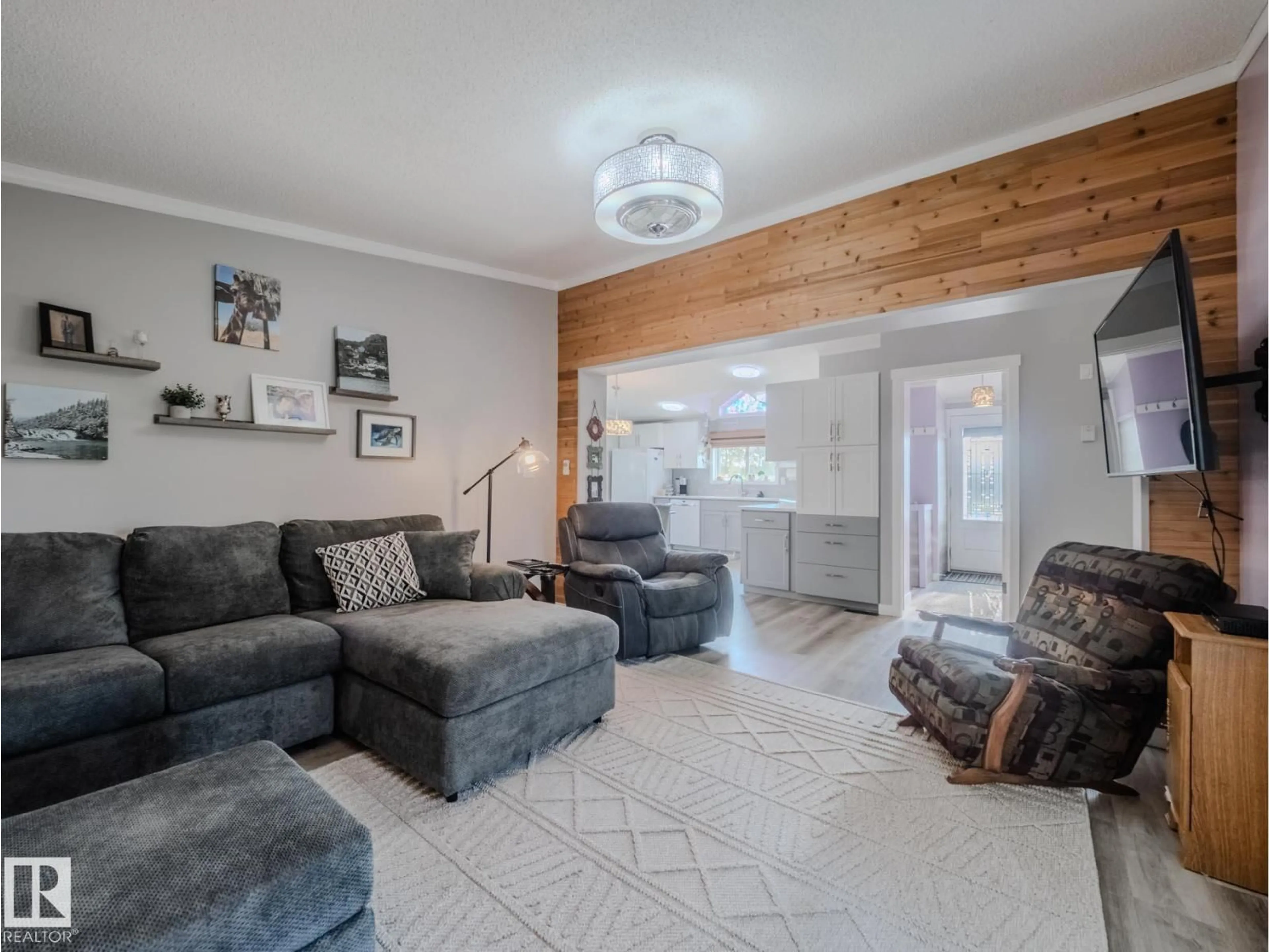 Living room with furniture, wood/laminate floor for 23021 TWP ROAD 502, Rural Leduc County Alberta T0B3M1