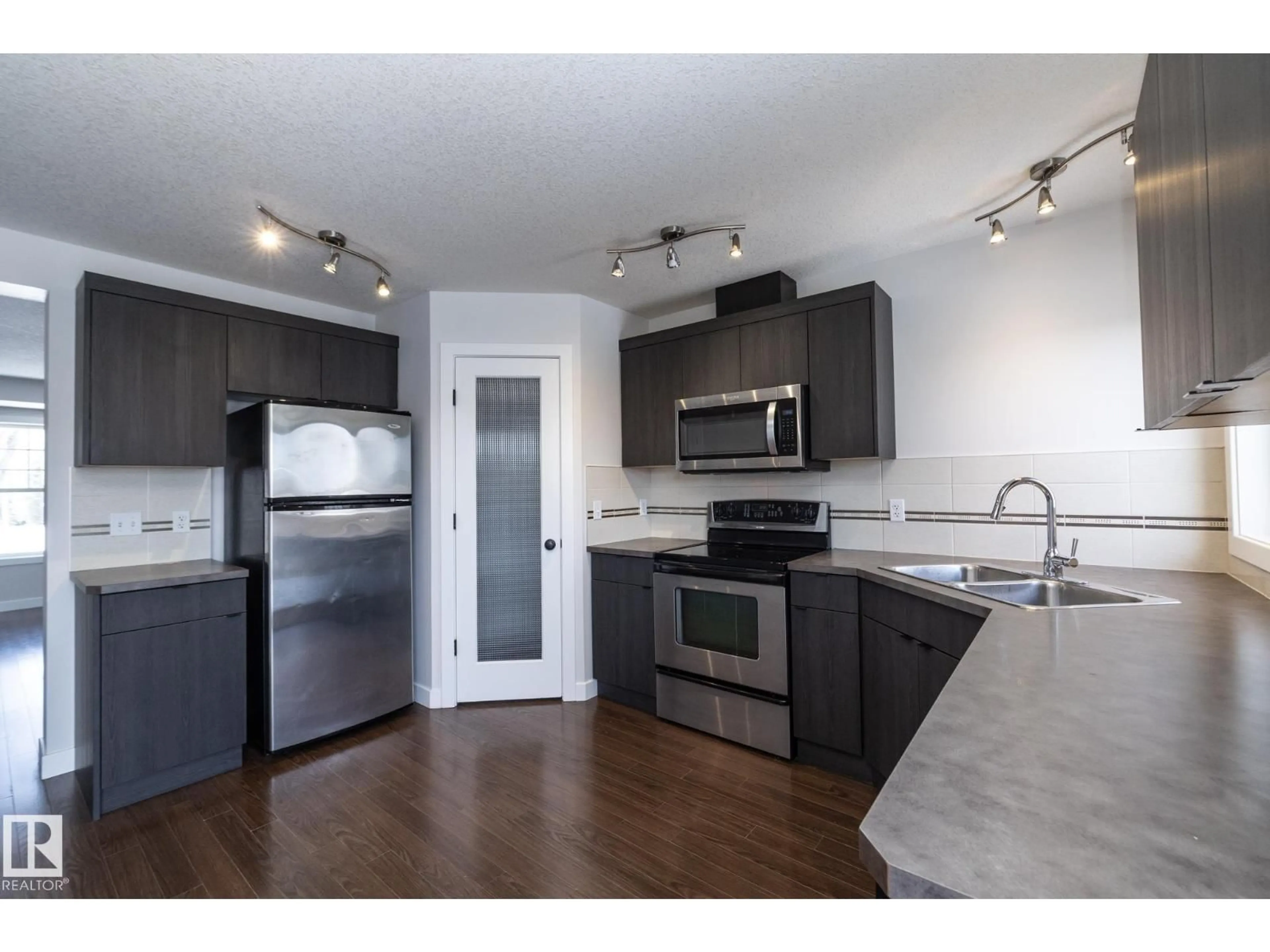 Open concept kitchen, wood/laminate floor for 197 BIRCHWOOD CL, Devon Alberta T9G0A5
