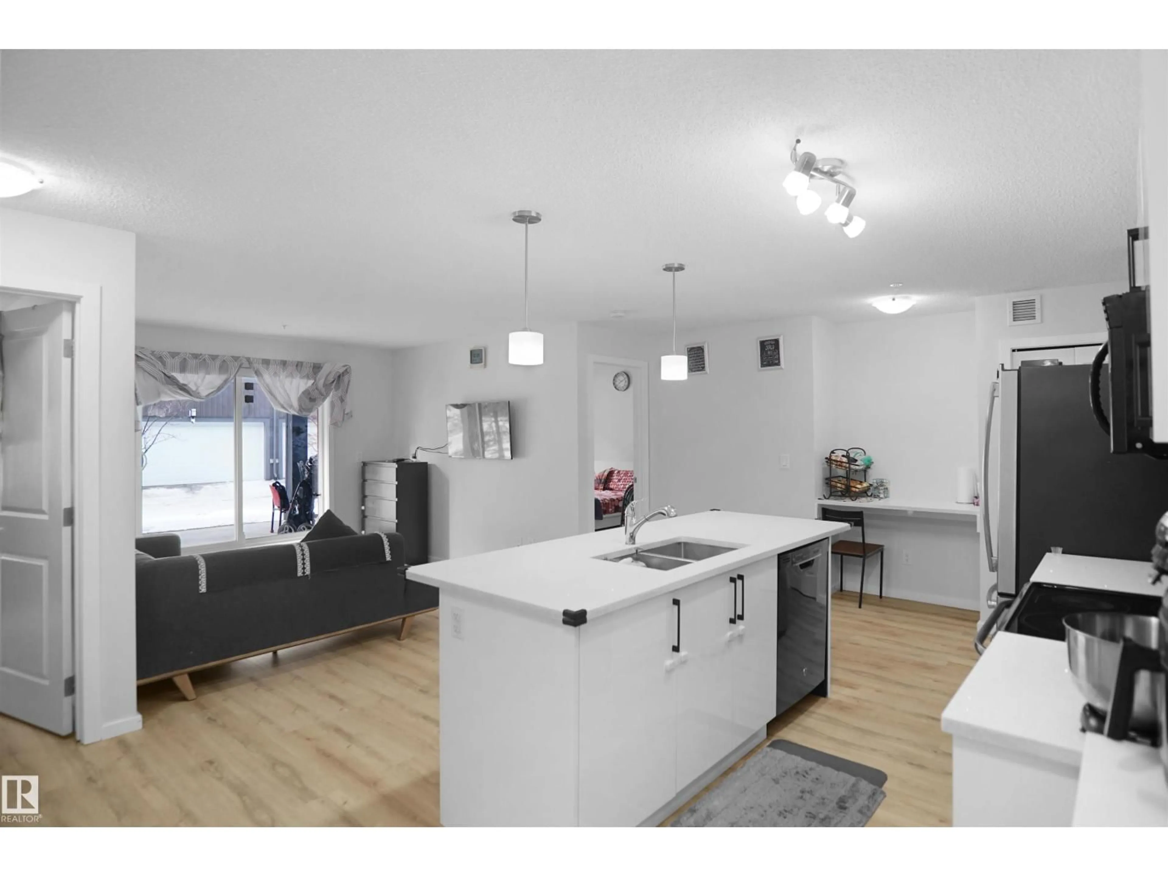 Open concept kitchen, wood/laminate floor for #103 - 3353 16A AV, Edmonton Alberta T6T0V4