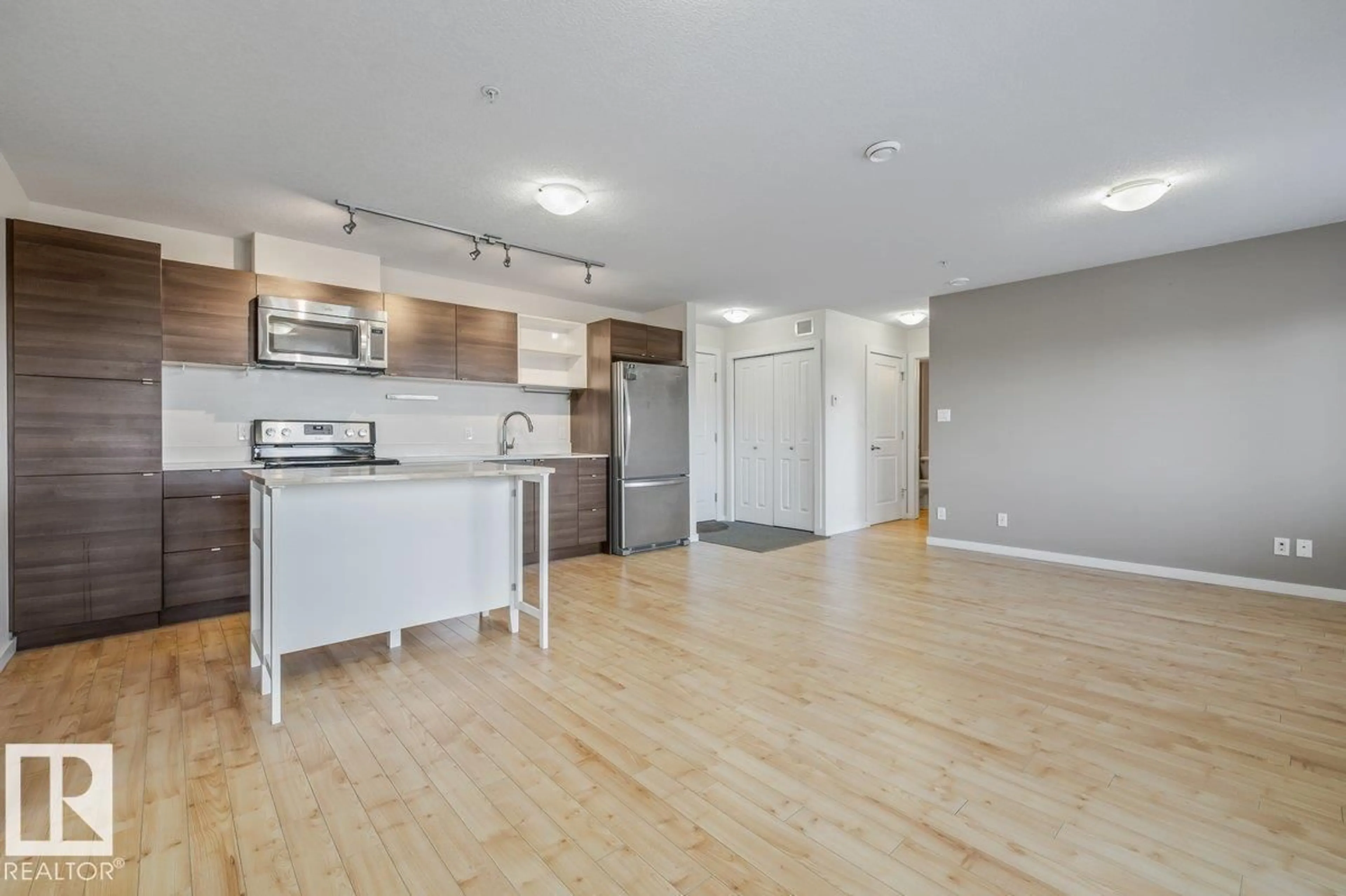 Open concept kitchen, wood/laminate floor for #305 - 9523 160 AV, Edmonton Alberta T5Z0M4