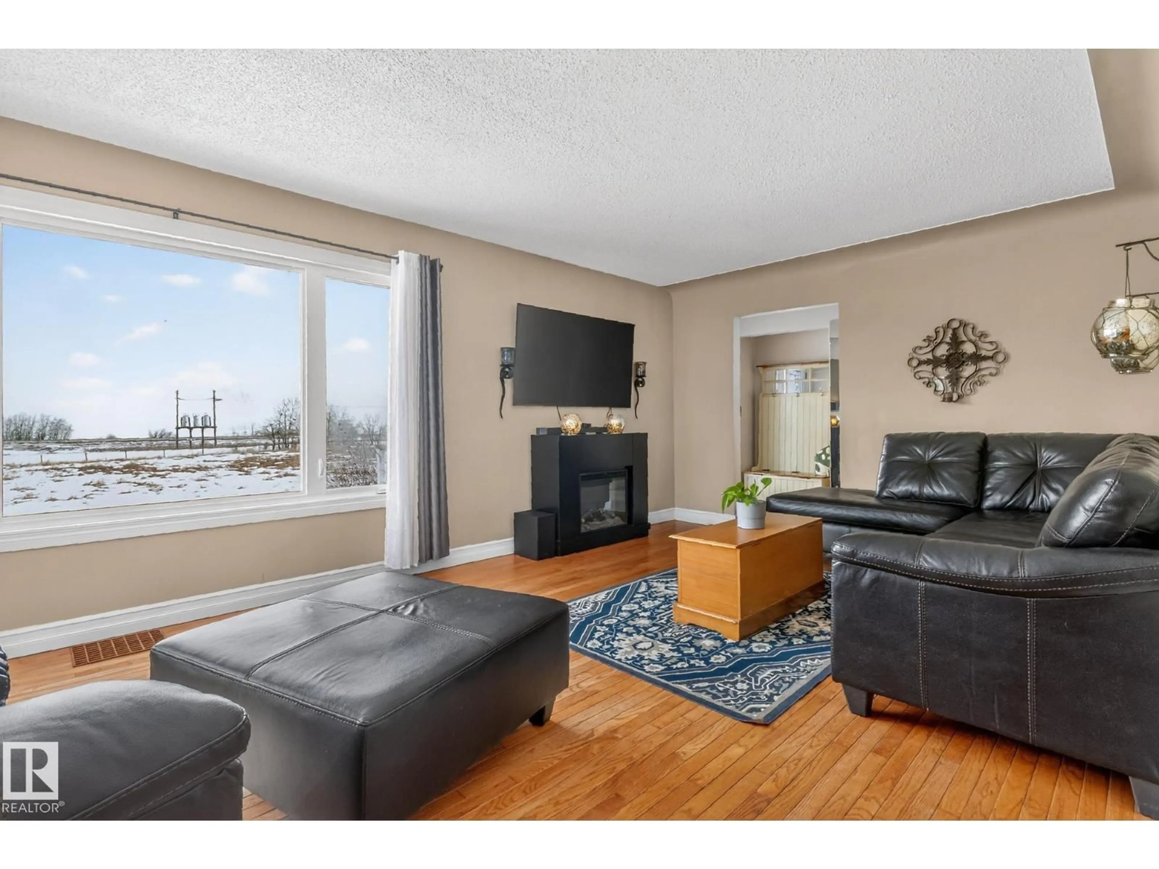 Living room with furniture, wood/laminate floor for 160068 TWP 531, Rural Lamont County Alberta T0B3H0