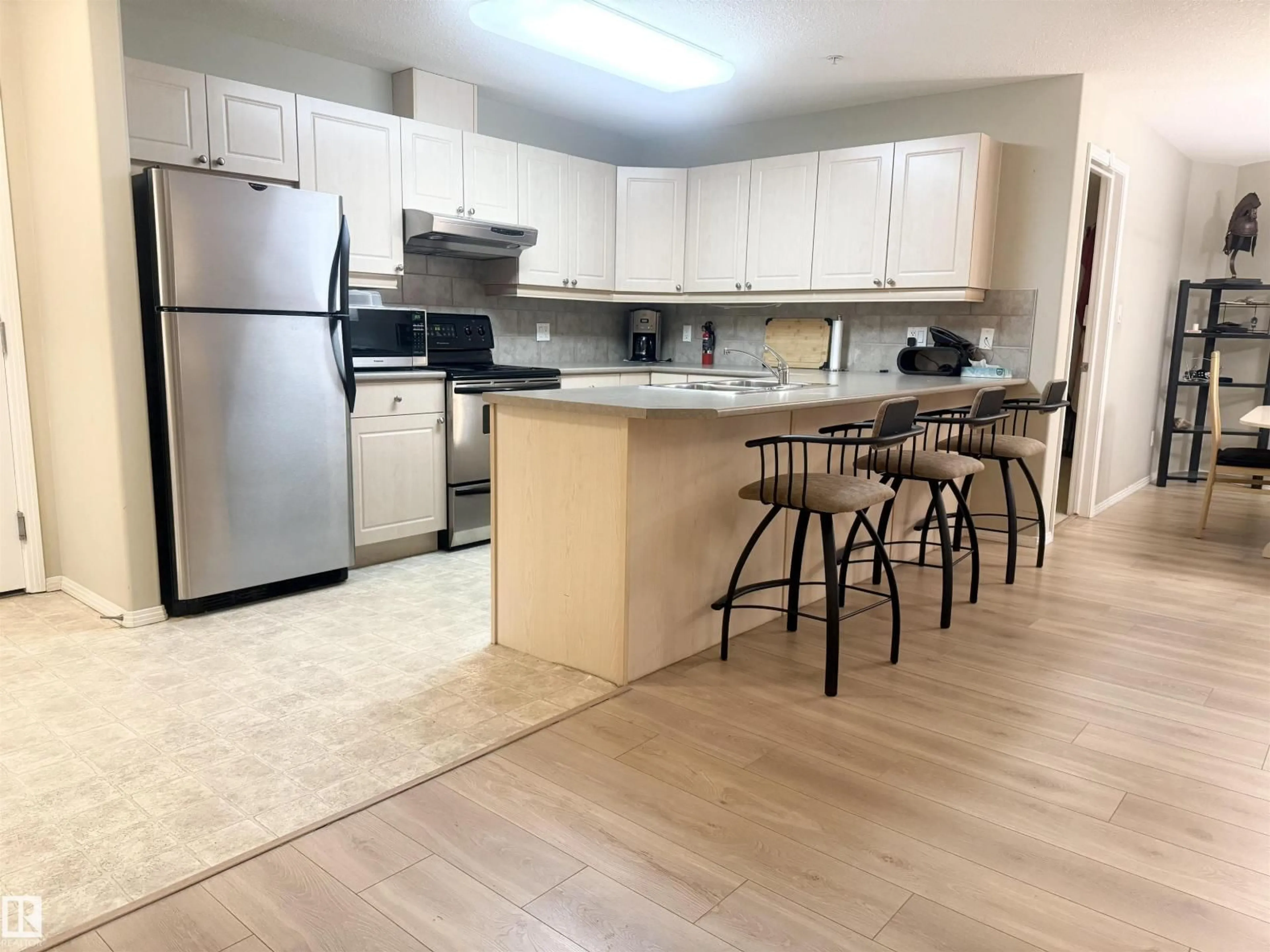 Open concept kitchen, wood/laminate floor for 592 - 315 HOOKE RD NW, Edmonton Alberta T5A5H2