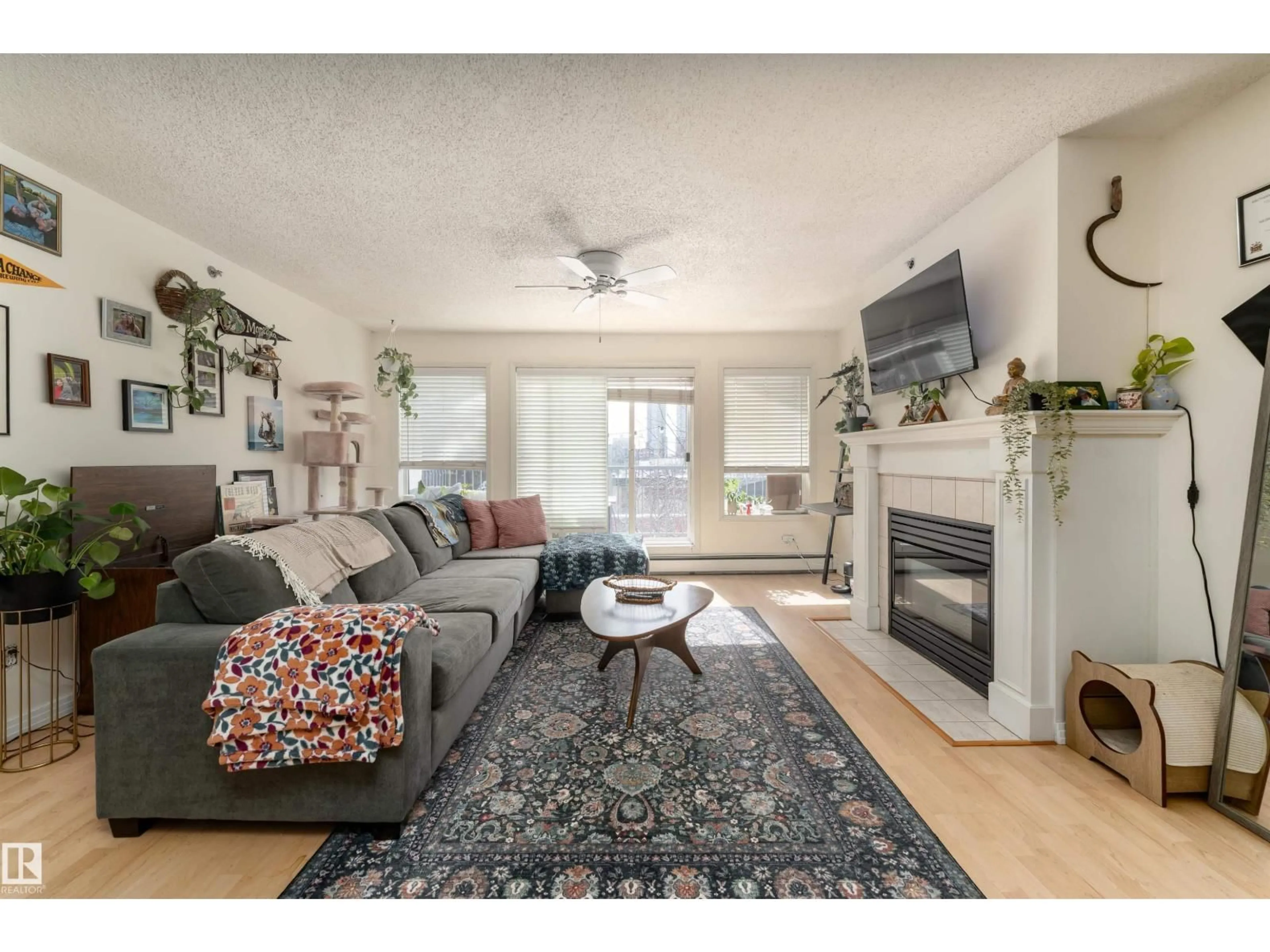 Living room with furniture, wood/laminate floor for 315 10508 119 ST NW, Edmonton Alberta T5H4M1