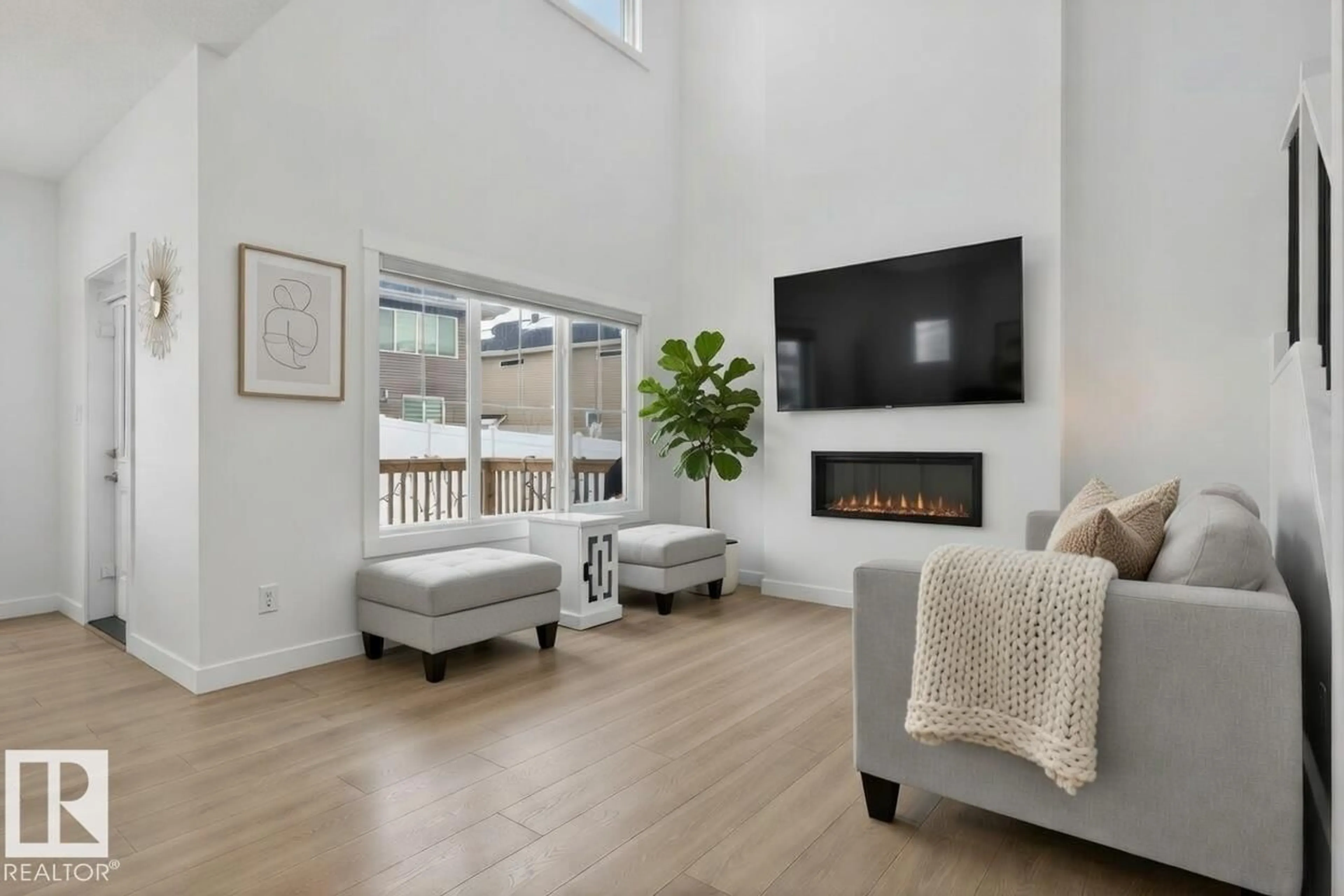 Living room with furniture, wood/laminate floor for NW - 7344 177 AV, Edmonton Alberta T5Z0V9