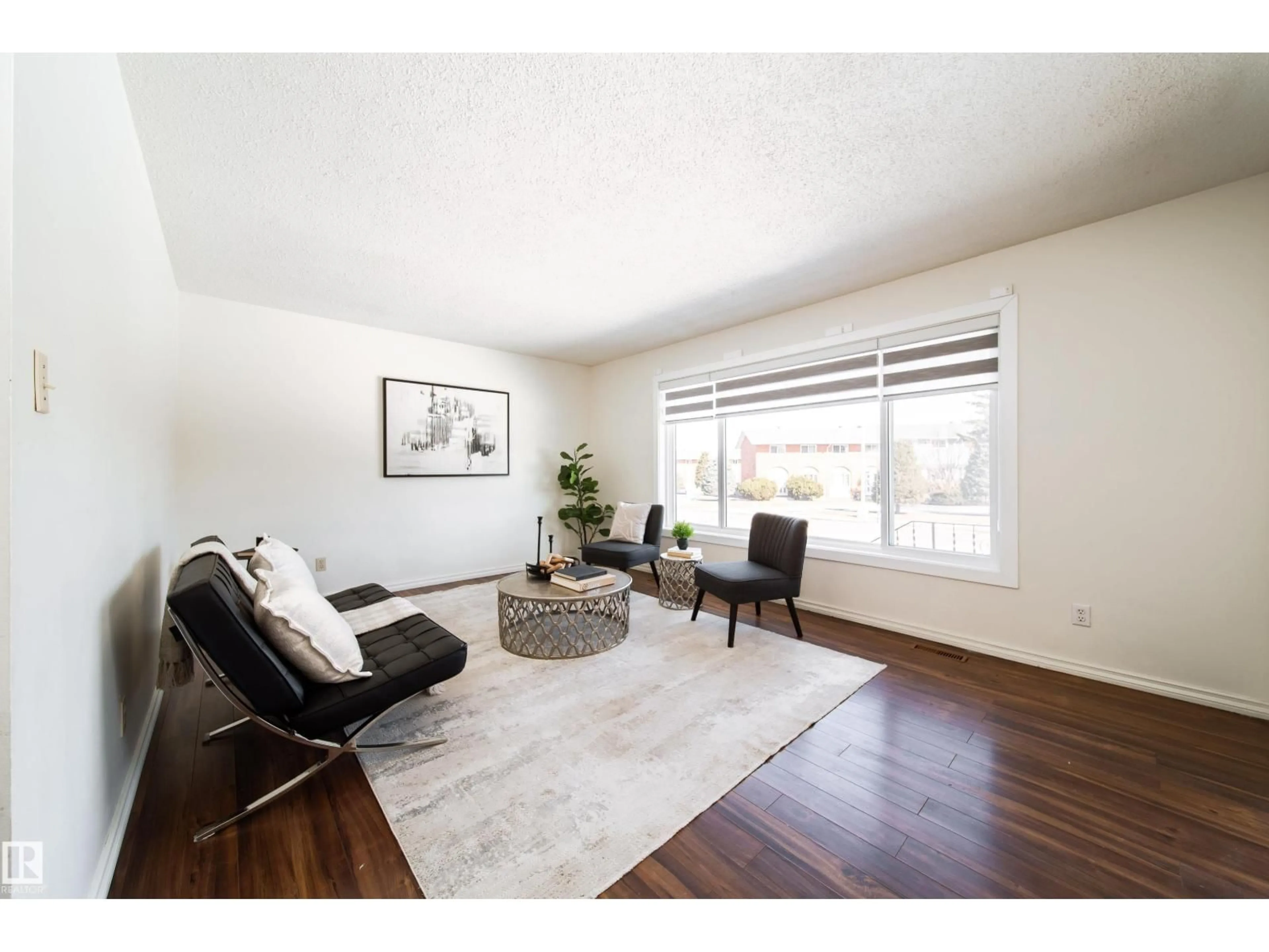 Living room with furniture, wood/laminate floor for 3518 78 ST, Edmonton Alberta T6K0E9