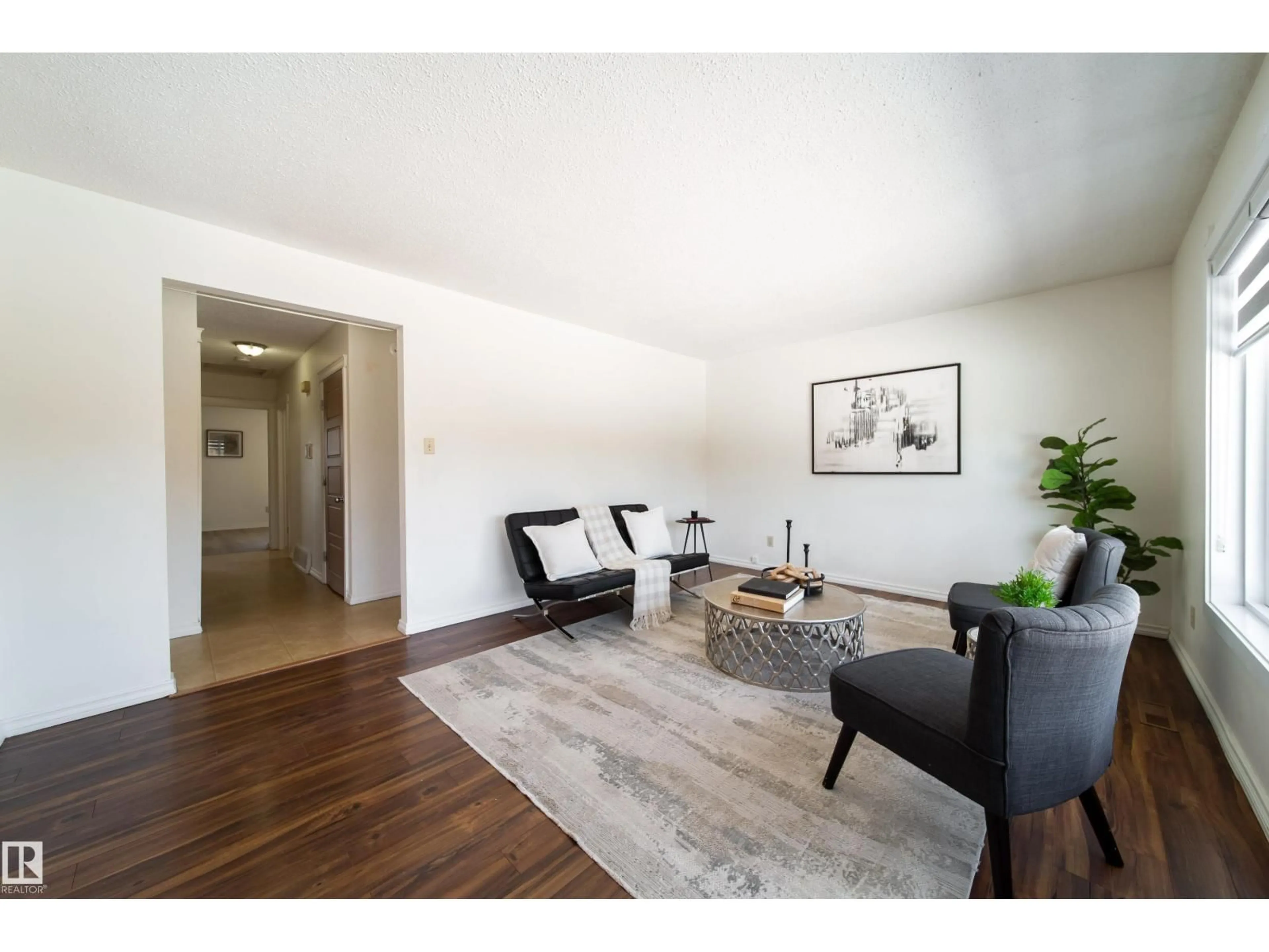 Living room with furniture, wood/laminate floor for 3518 78 ST, Edmonton Alberta T6K0E9
