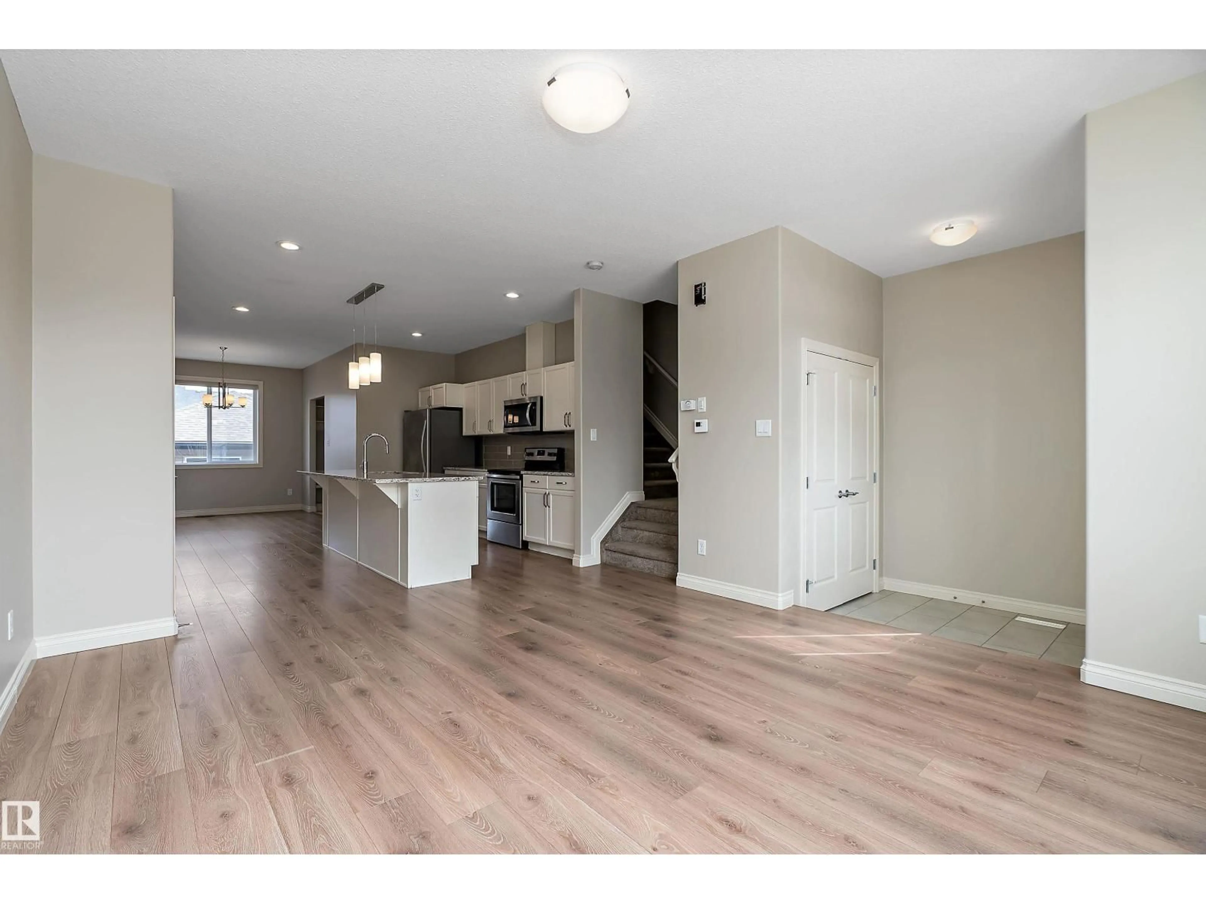 Open concept kitchen, wood/laminate floor for 8707 221 ST, Edmonton Alberta T5T7H7