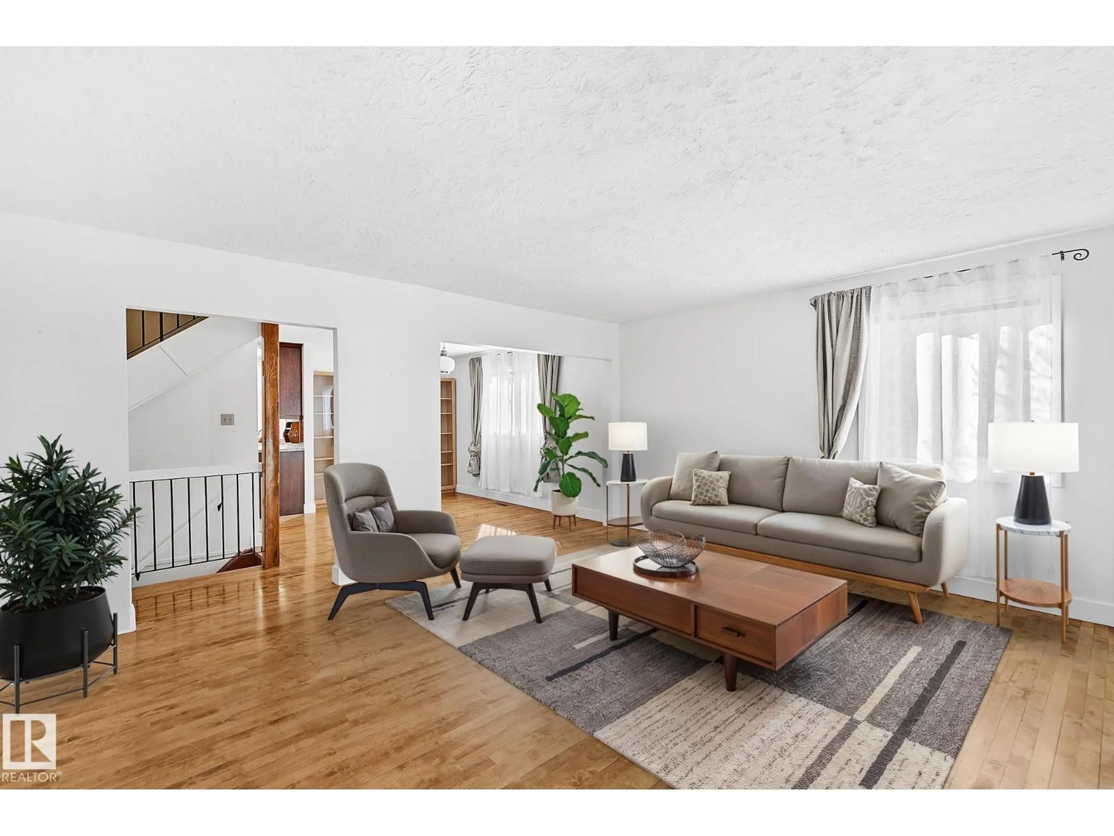 Living room with furniture, wood/laminate floor for NW - 10823 130 ST, Edmonton Alberta T5M0Z2