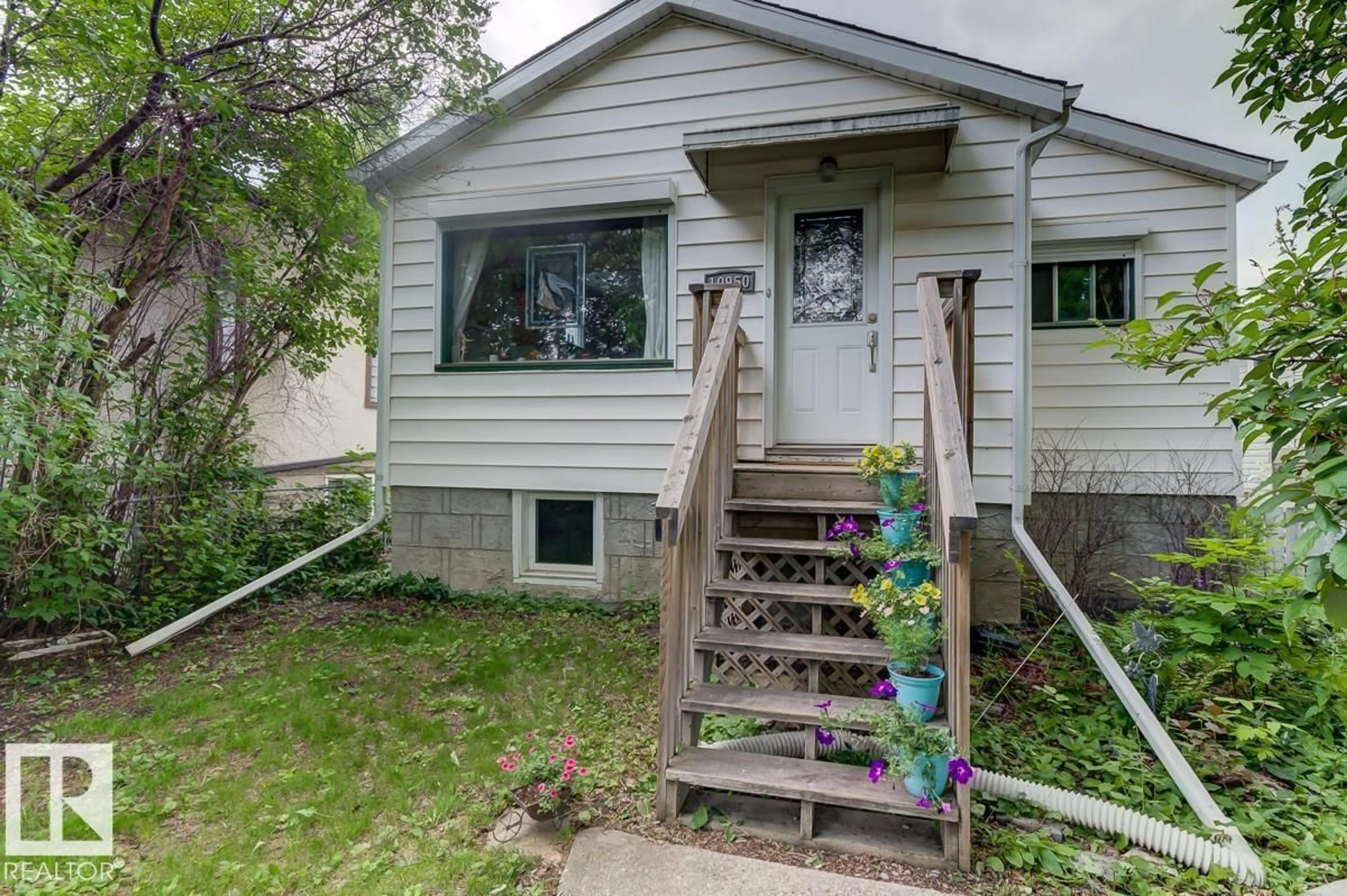 Home with vinyl exterior material, street for 10950 73 AV, Edmonton Alberta T6G0C2