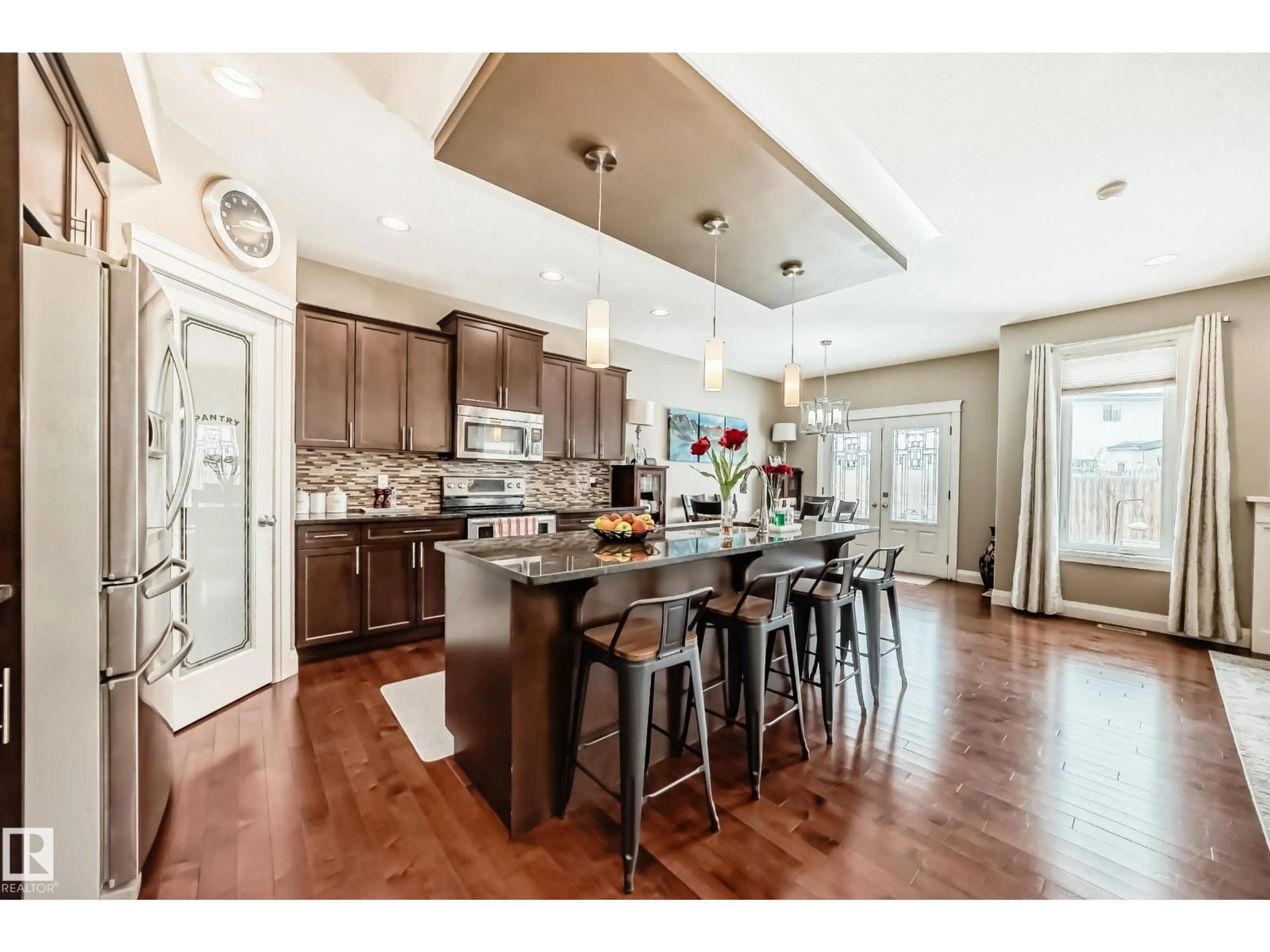 Open concept kitchen, wood/laminate floor for 3220 151 AV, Edmonton Alberta T5Y0J9