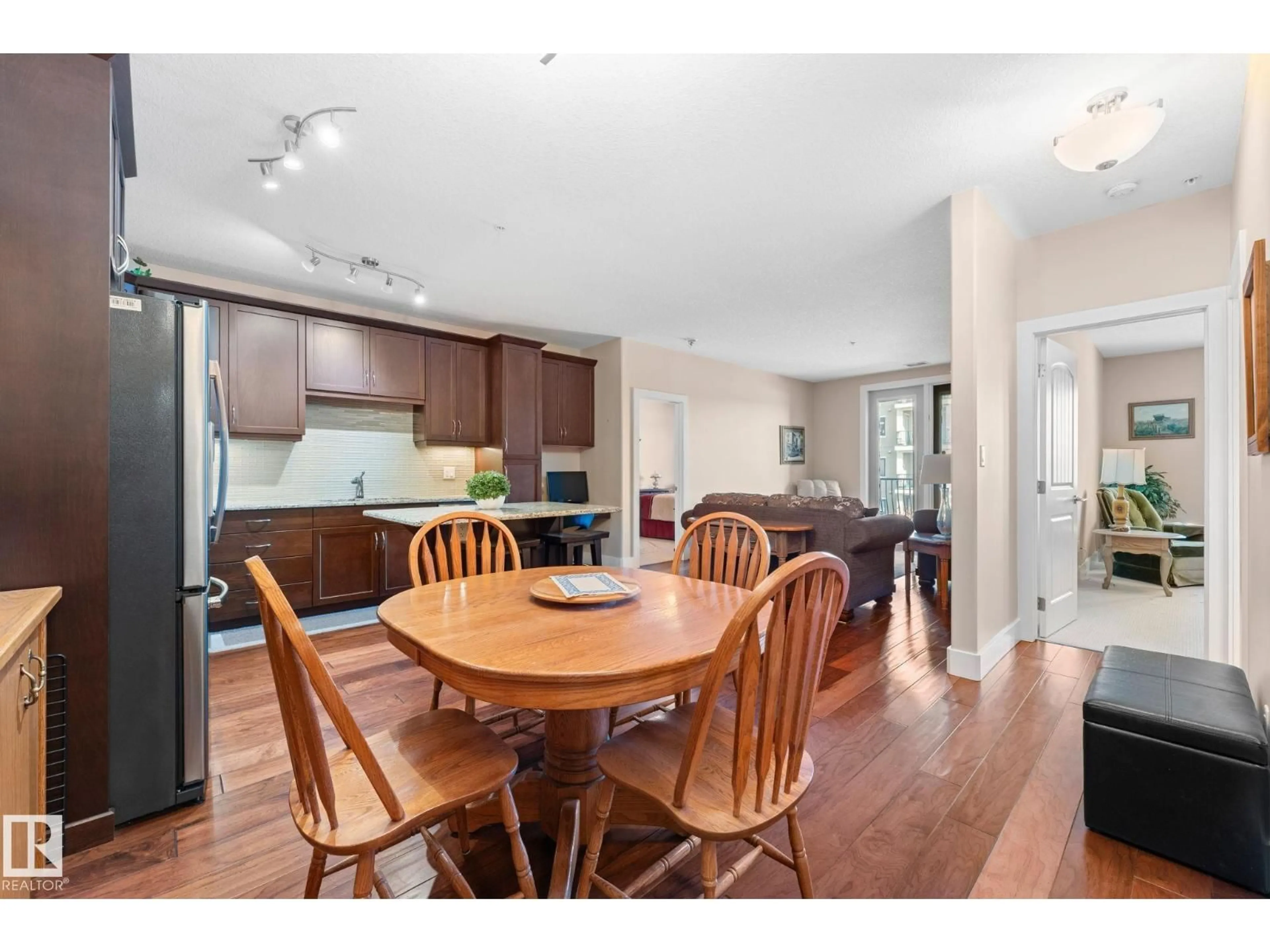 Open concept kitchen, wood/laminate floor for 251 - 6079 MAYNARD WY, Edmonton Alberta T6R0B4