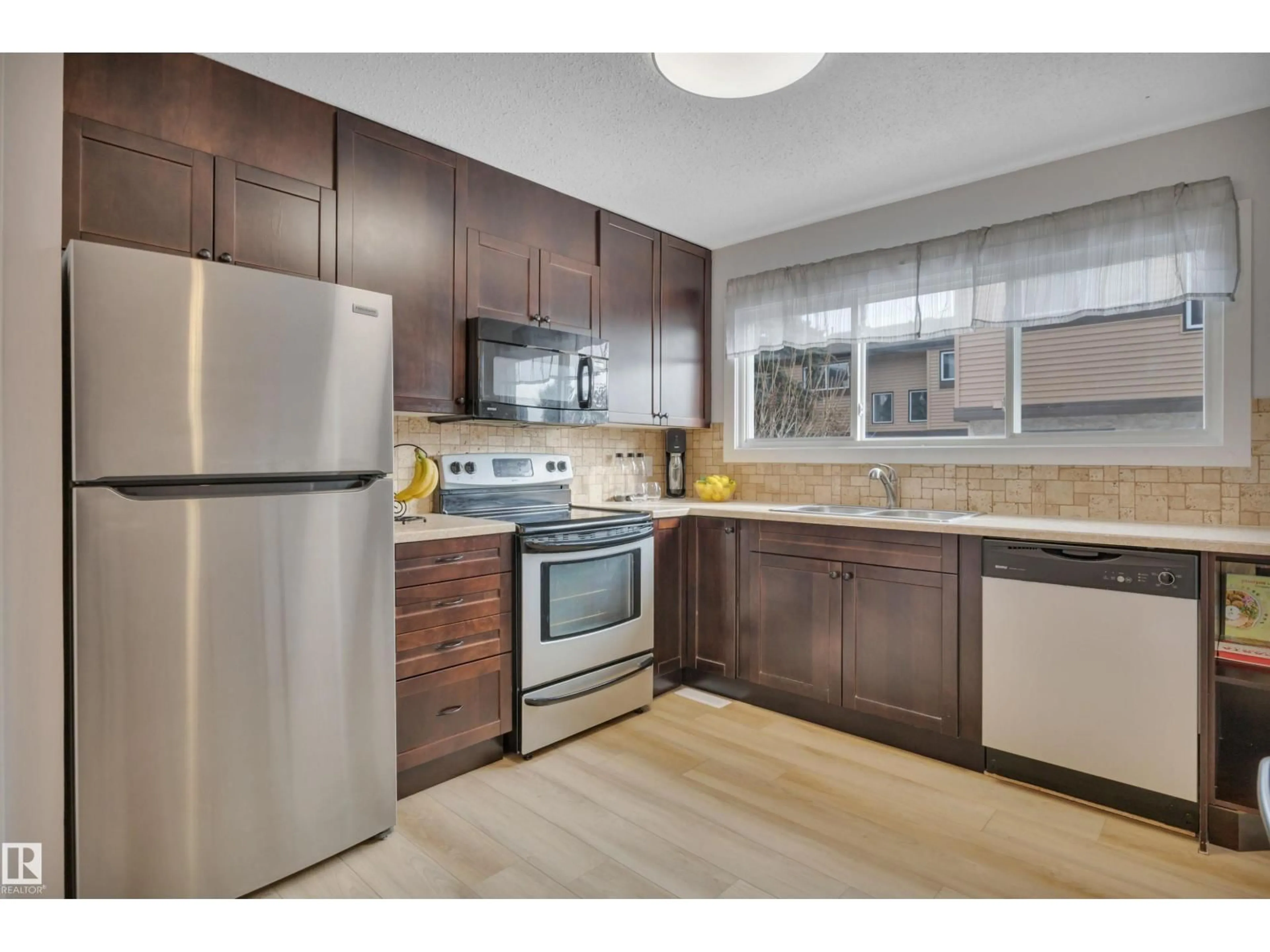 Standard kitchen, wood/laminate floor for 585 KNOTTWOOD RD W, Edmonton Alberta T5B4B6