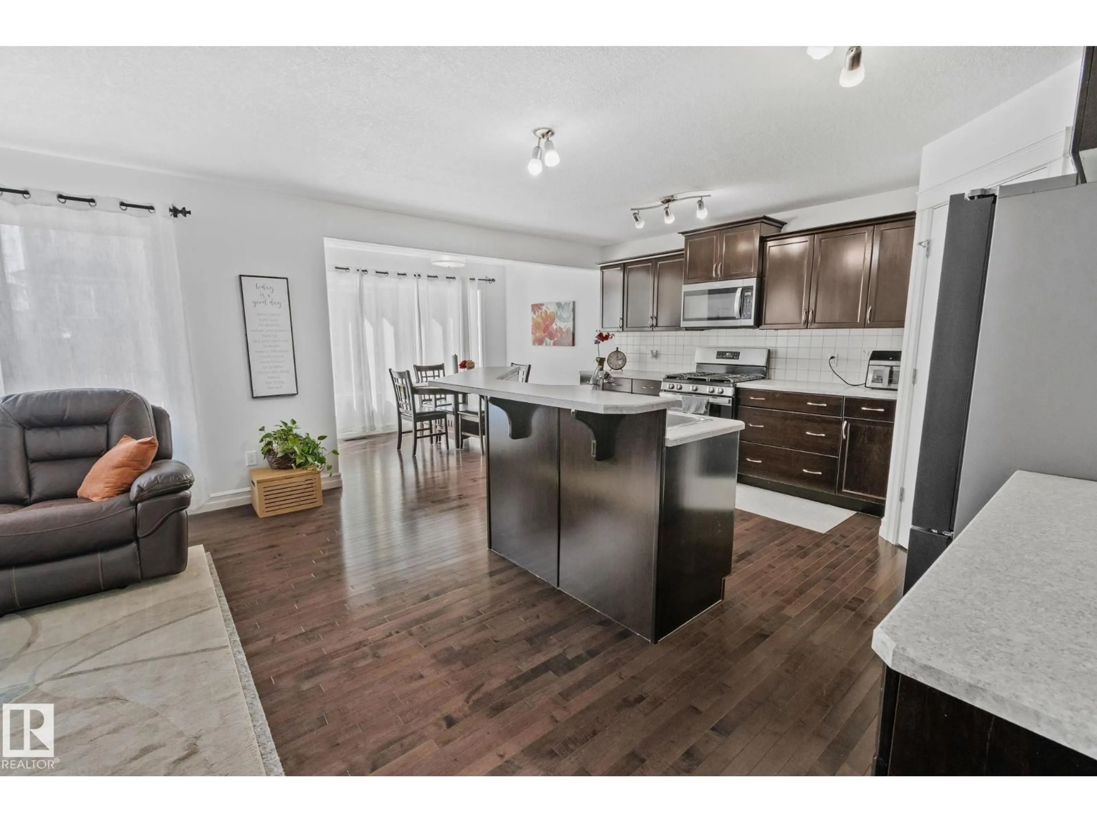 Open concept kitchen, wood/laminate floor for SW - 1115 61 ST, Edmonton Alberta T6X0M5
