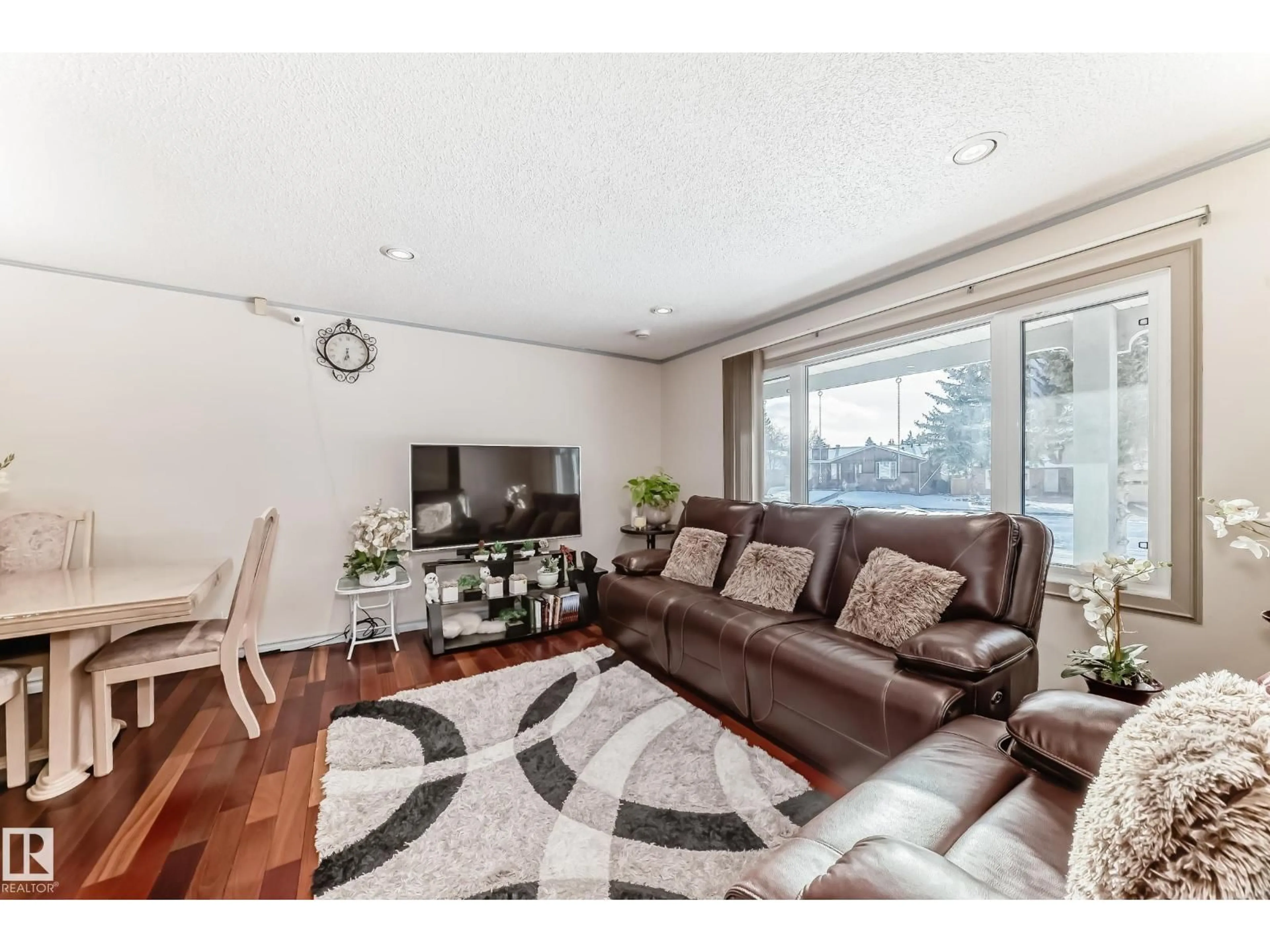 Living room with furniture, wood/laminate floor for 8733 181A ST, Edmonton Alberta T5T0Y7