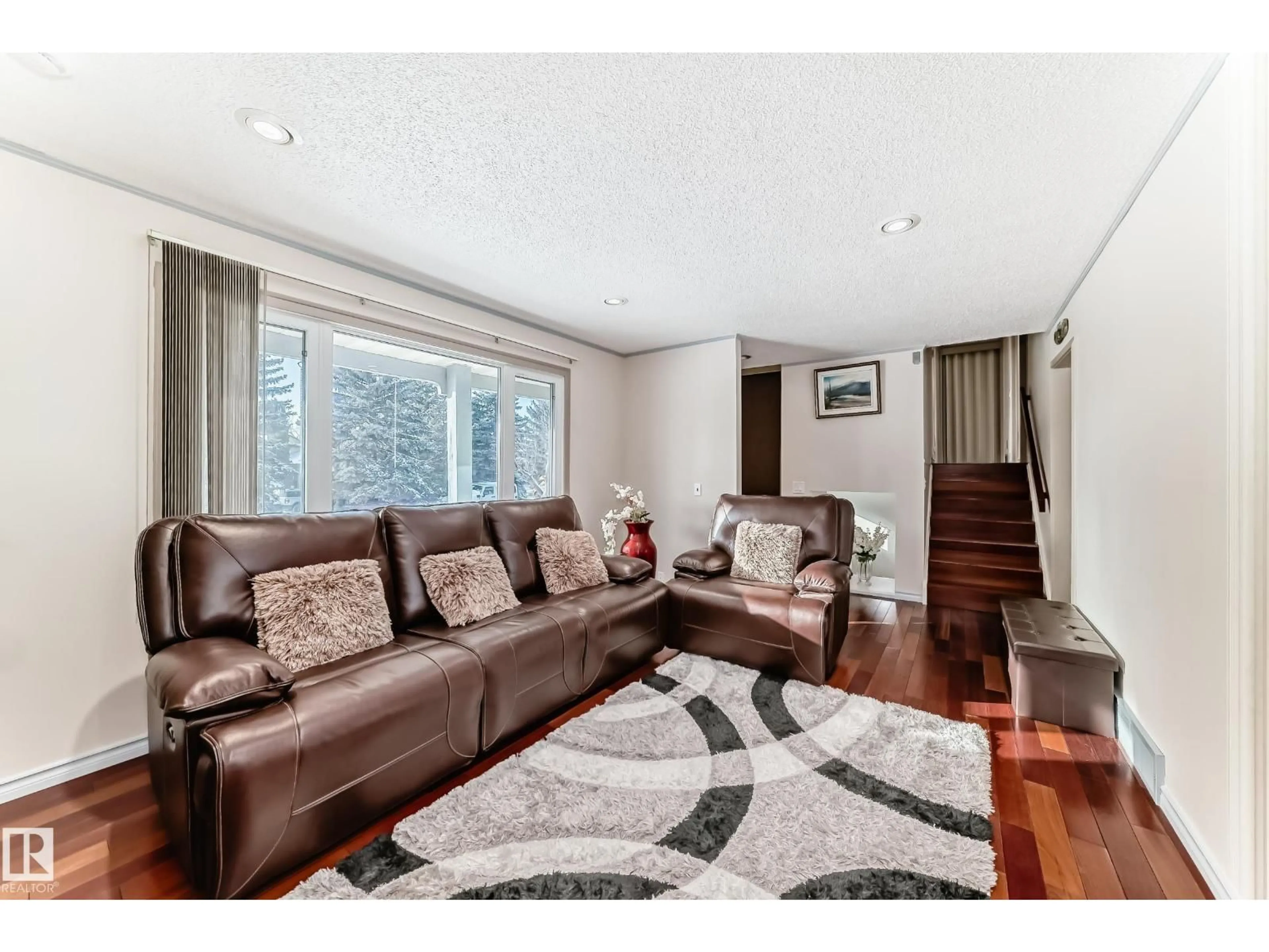 Living room with furniture, wood/laminate floor for 8733 181A ST, Edmonton Alberta T5T0Y7