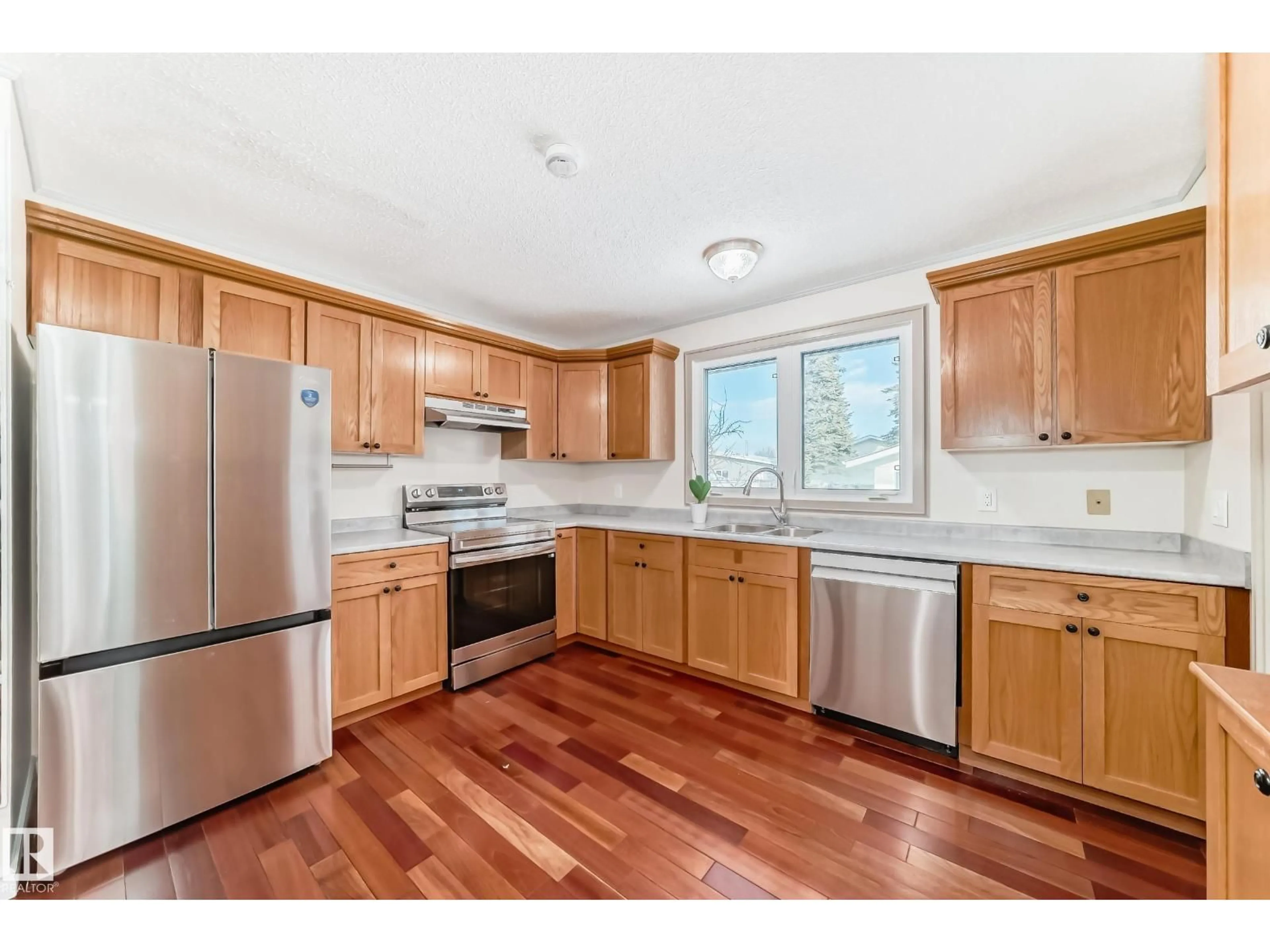 Open concept kitchen, wood/laminate floor for 8733 181A ST, Edmonton Alberta T5T0Y7