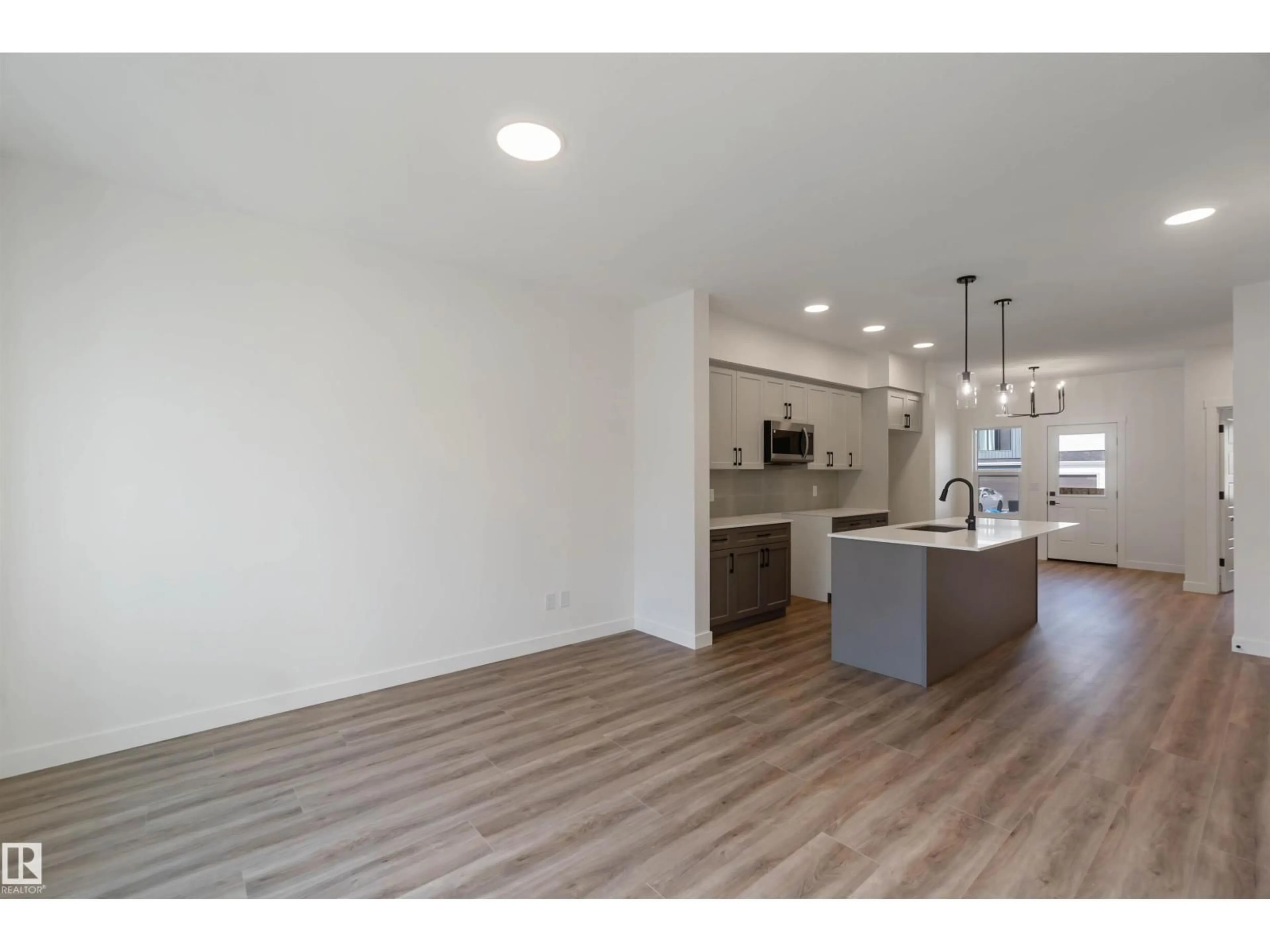 Open concept kitchen, wood/laminate floor for 1003 ASTER BV, Edmonton Alberta T6T2W8