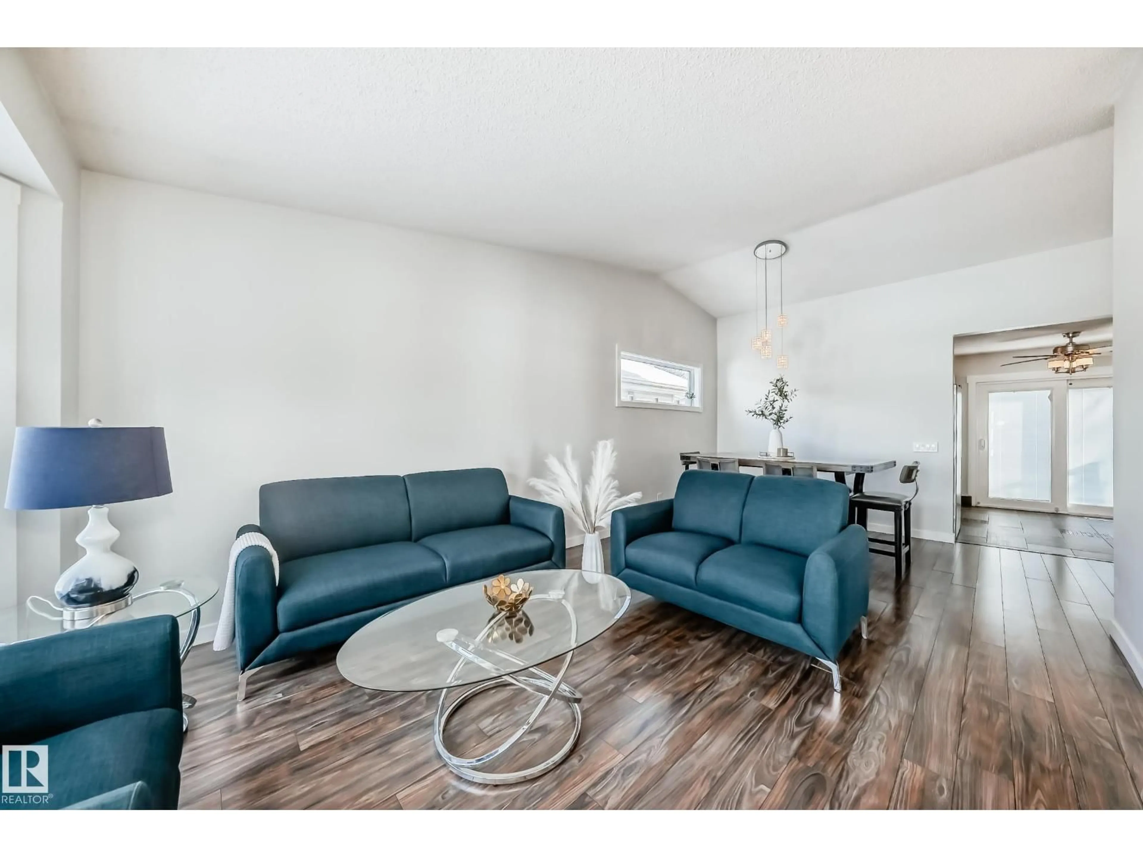 Living room with furniture, wood/laminate floor for NW - 7011 190B ST, Edmonton Alberta T5T5Z6