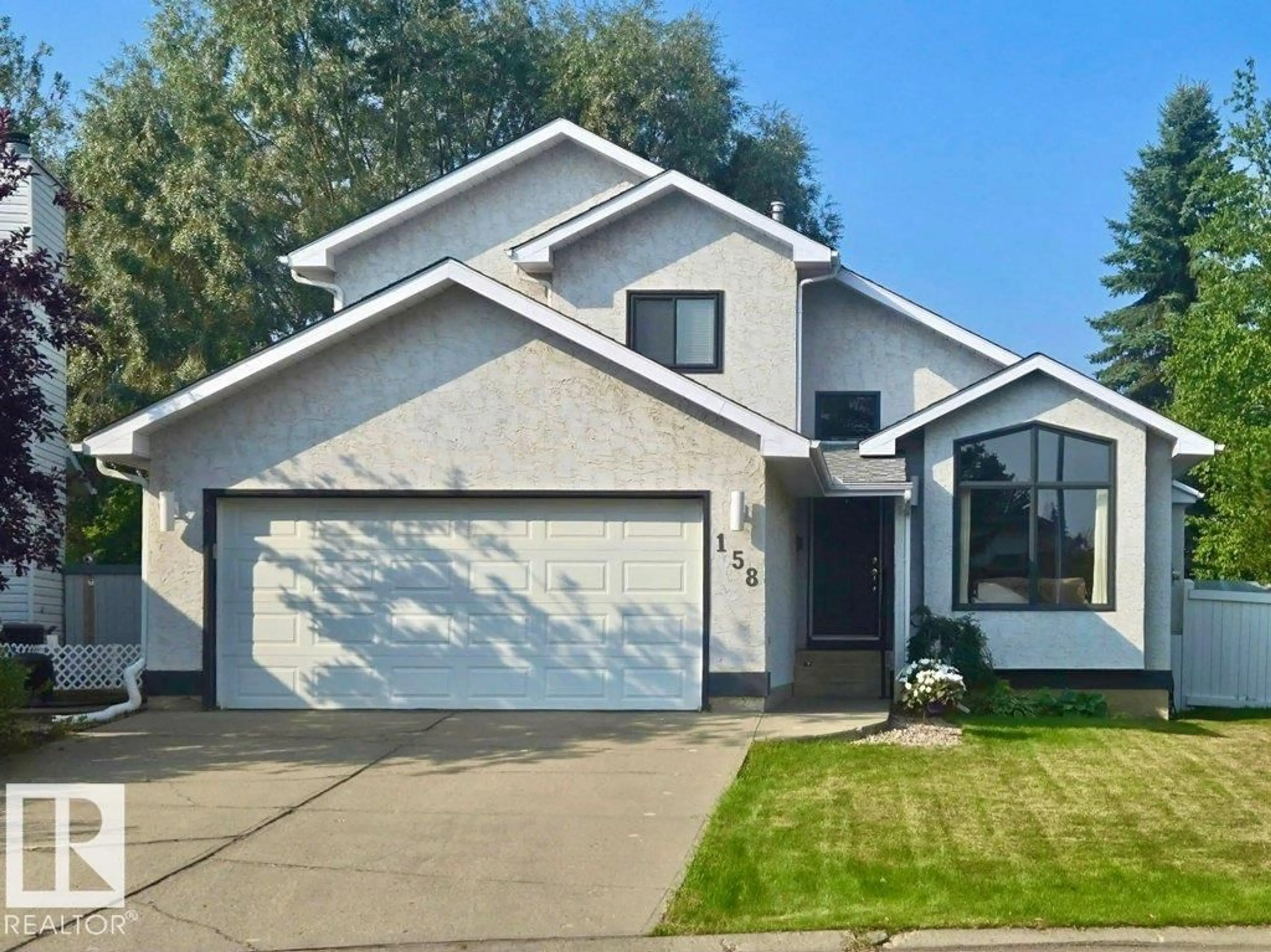 Home with vinyl exterior material, street for 158 RHATIGAN RD E, Edmonton Alberta T6R1N2