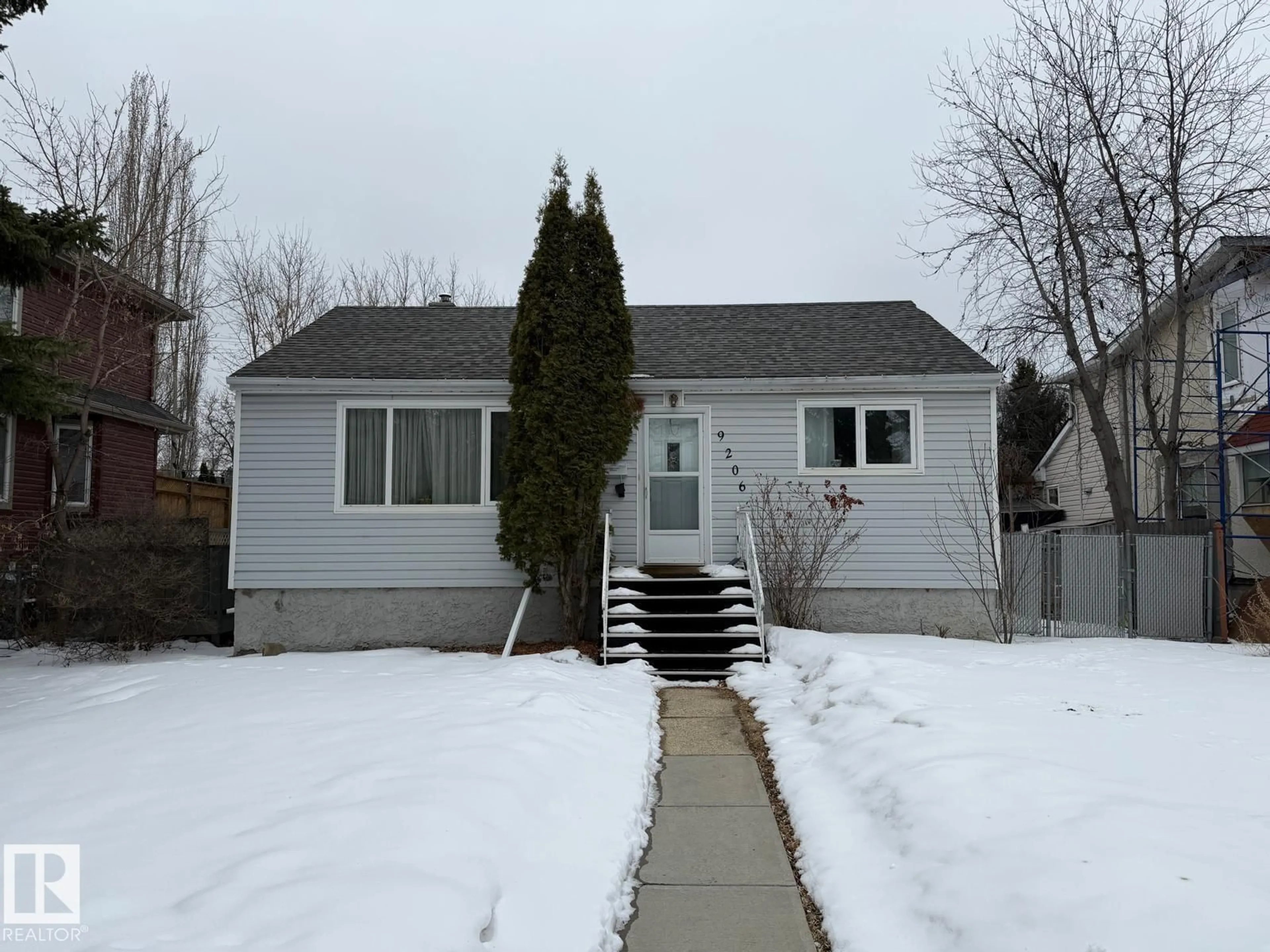 Home with vinyl exterior material, street for NW - 9206 / 9208 90 ST, Edmonton Alberta T6C3M1