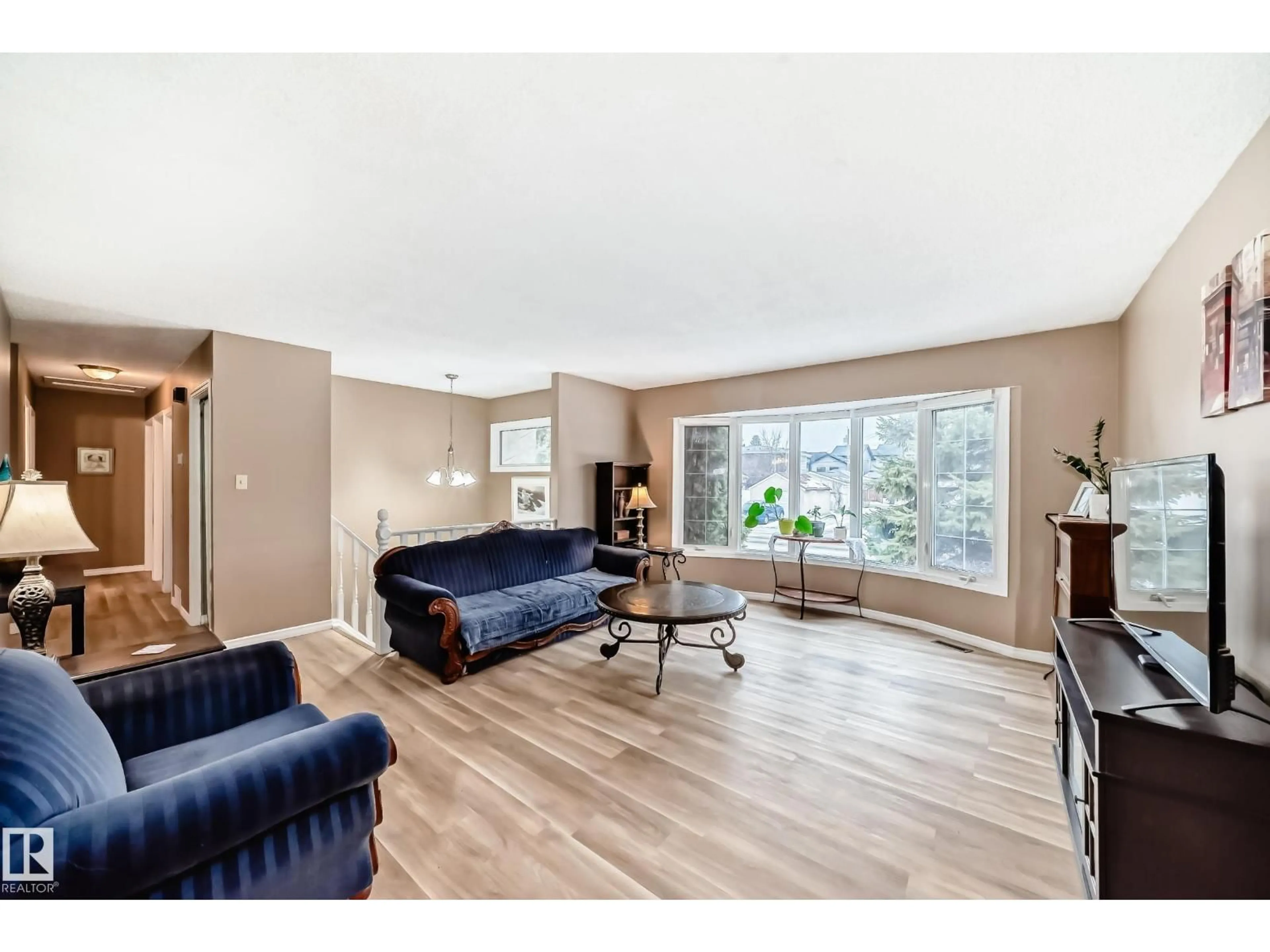 Living room with furniture, wood/laminate floor for NW - 9813 152 ST, Edmonton Alberta T5P1X2