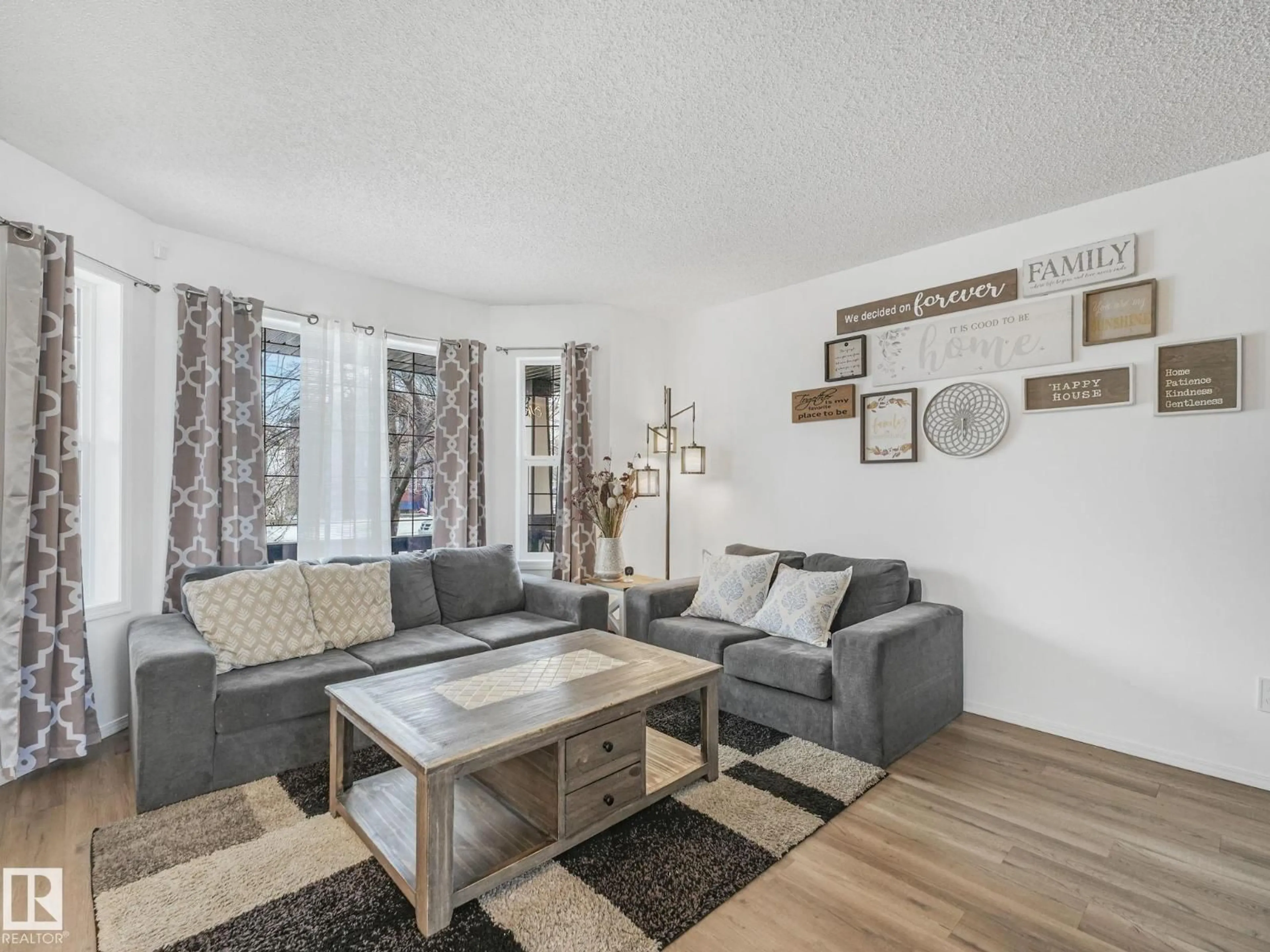 Living room with furniture, wood/laminate floor for NW - 21360 88 AV, Edmonton Alberta T5T6V1