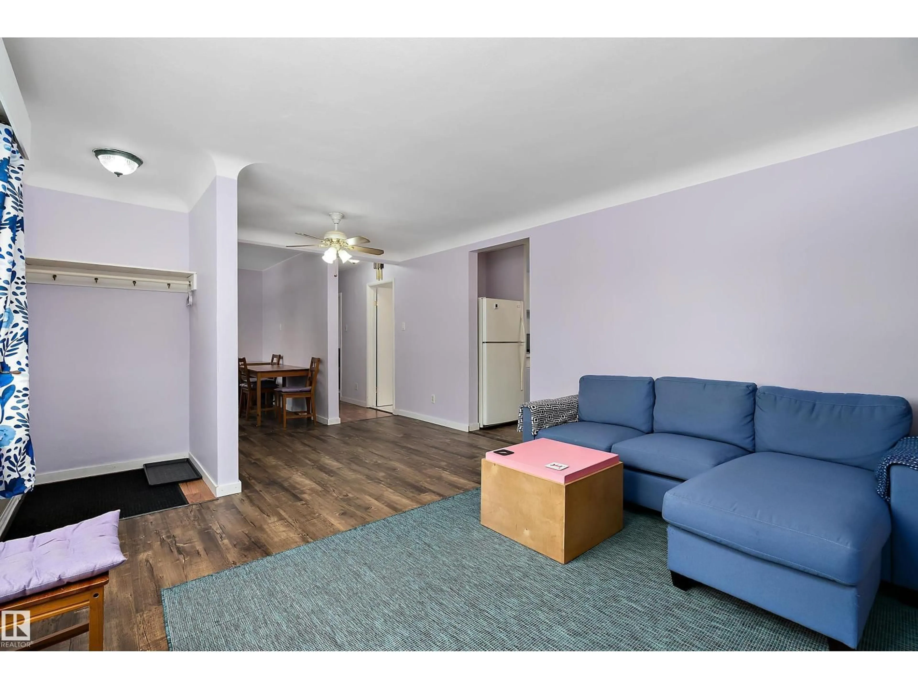 Living room with furniture, wood/laminate floor for 7720 85 AV, Edmonton Alberta T6C1G1